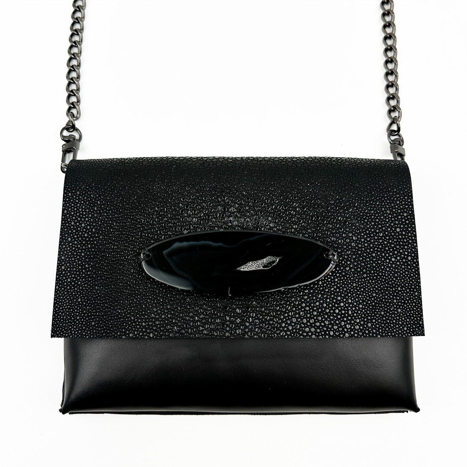 The BAHAMA - BLACK STINGRAY by evokewomen, an Italian leather handbag featuring a textured flap and a metal chain strap, exudes exotic allure and is perfect for those seeking style in a cross body bag.