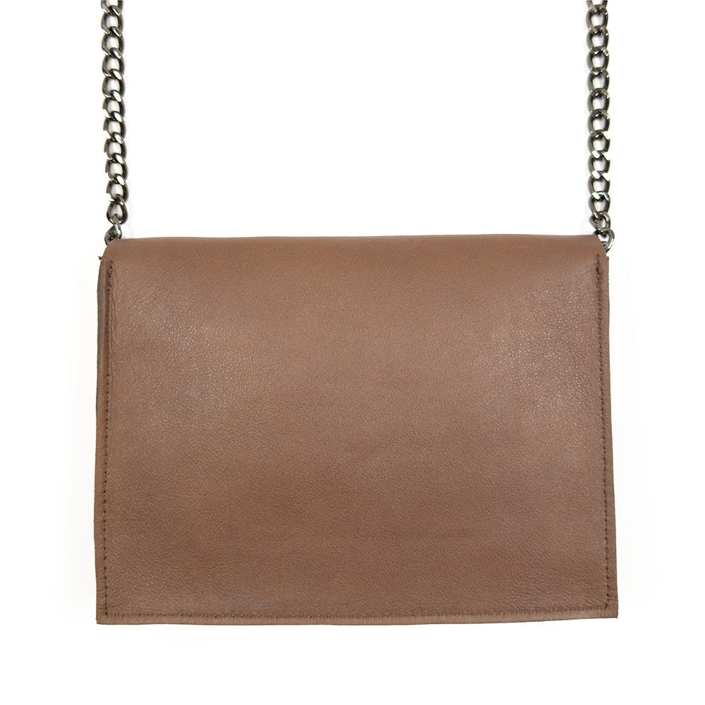 The BAHAMA - nutshell by evokewomen is a brown Italian leather purse with a flap and a silver chain strap, offering versatile style and functionality as a crossbody bag.