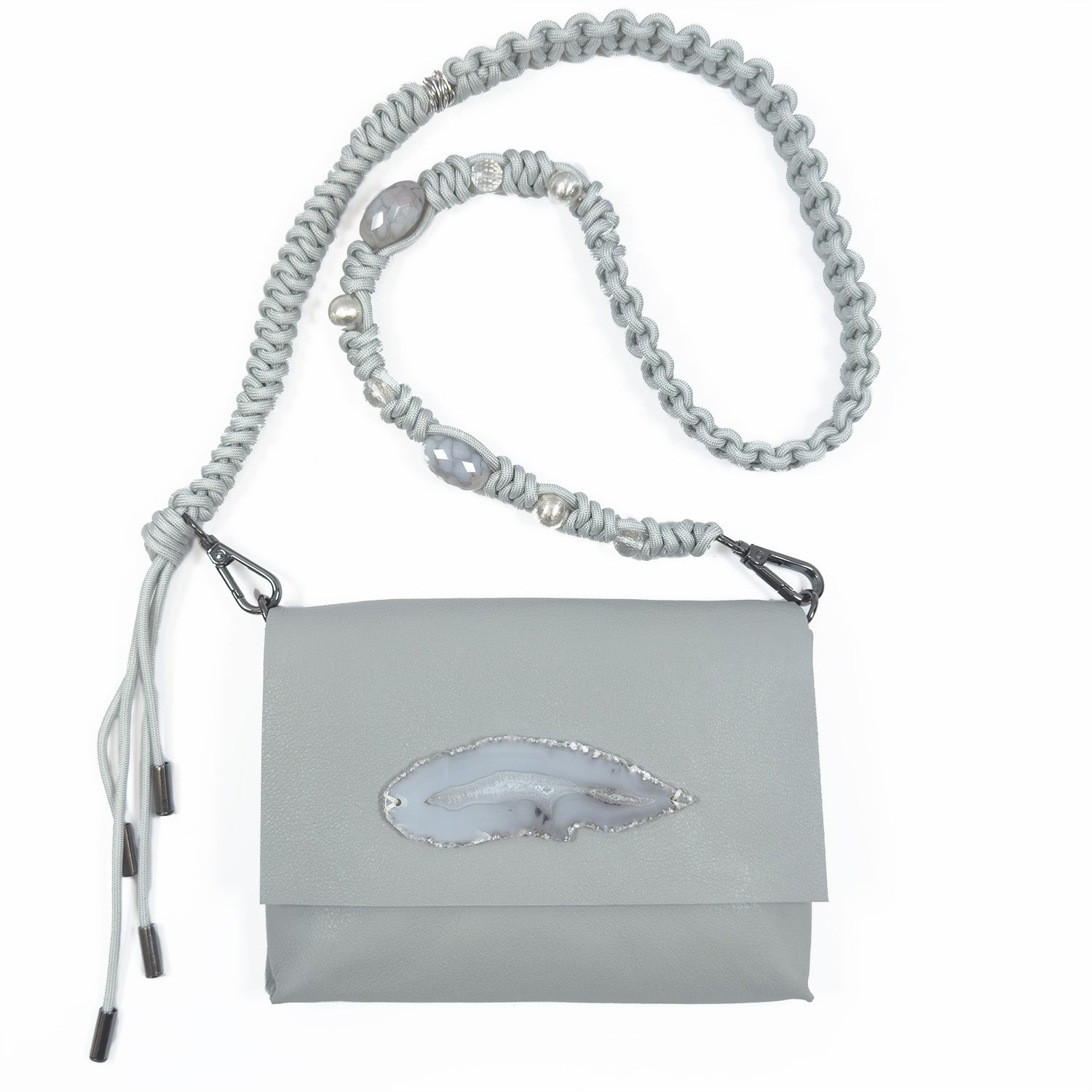 The BAHAMA - LIGHT SMOKE - knotted strap by evokewomen showcases exquisite gray Italian leather adorned with an agate stone detail. It features a decorative strap crafted from beads and braided rope, finished with a stylish knotted shoulder strap.