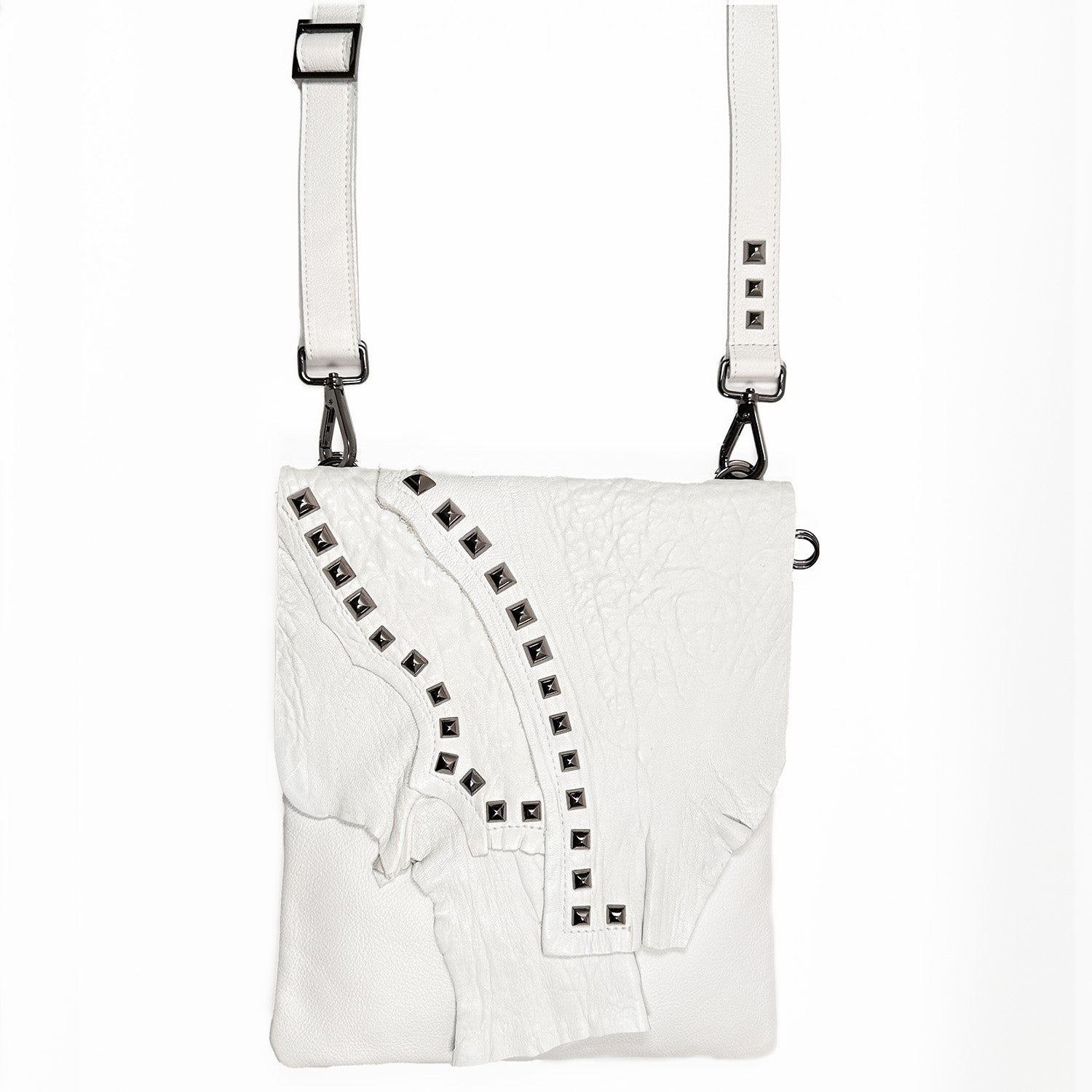 The DRITA - white by evokewomen is an Italian leather shoulder bag featuring a textured flap, metal stud accents, and an adjustable strap for versatile crossbody wear.