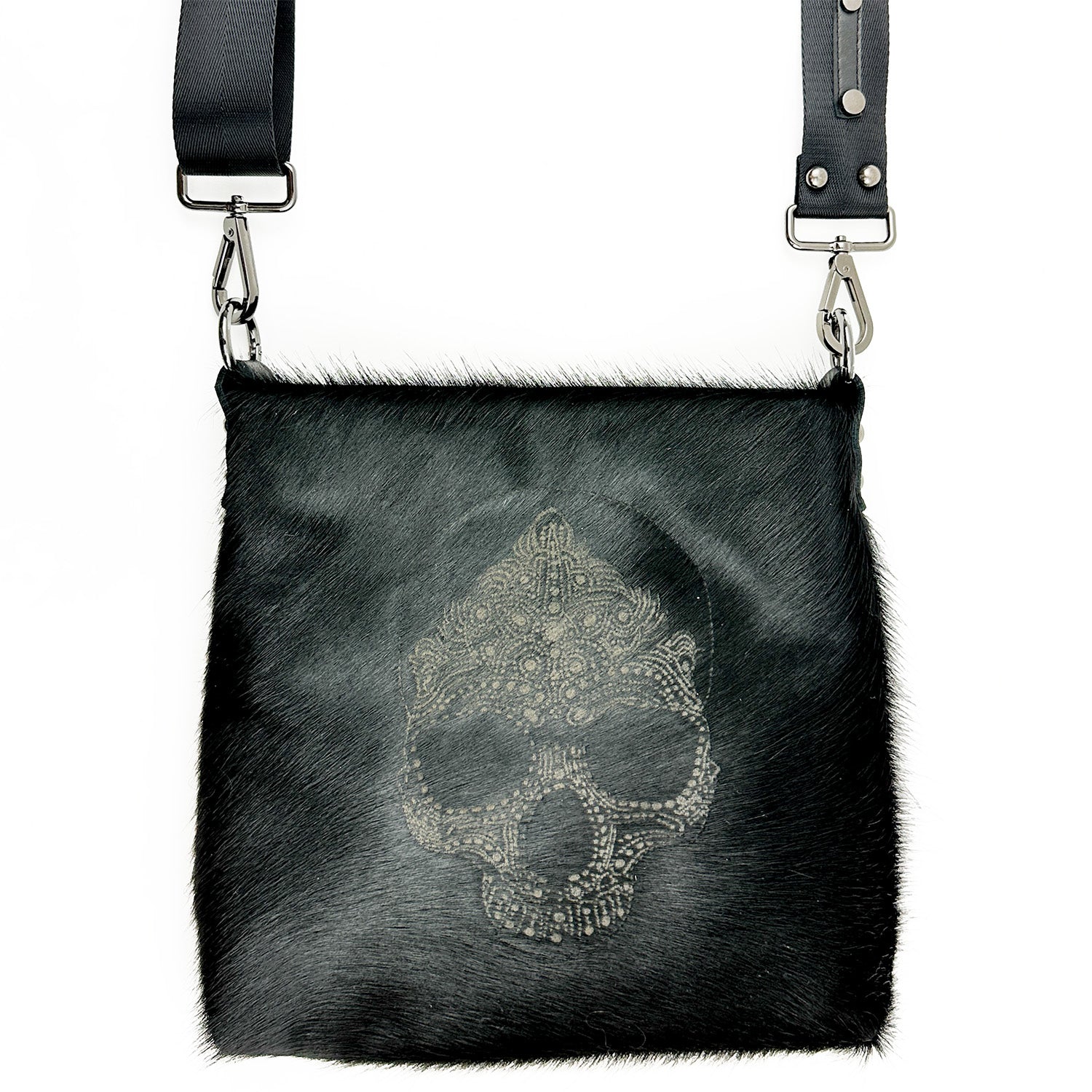 The ENYA - BLACK LASER SKULL by evokewomen is a black fur crossbody bag with an intricate skull design on the front and Italian leather straps.