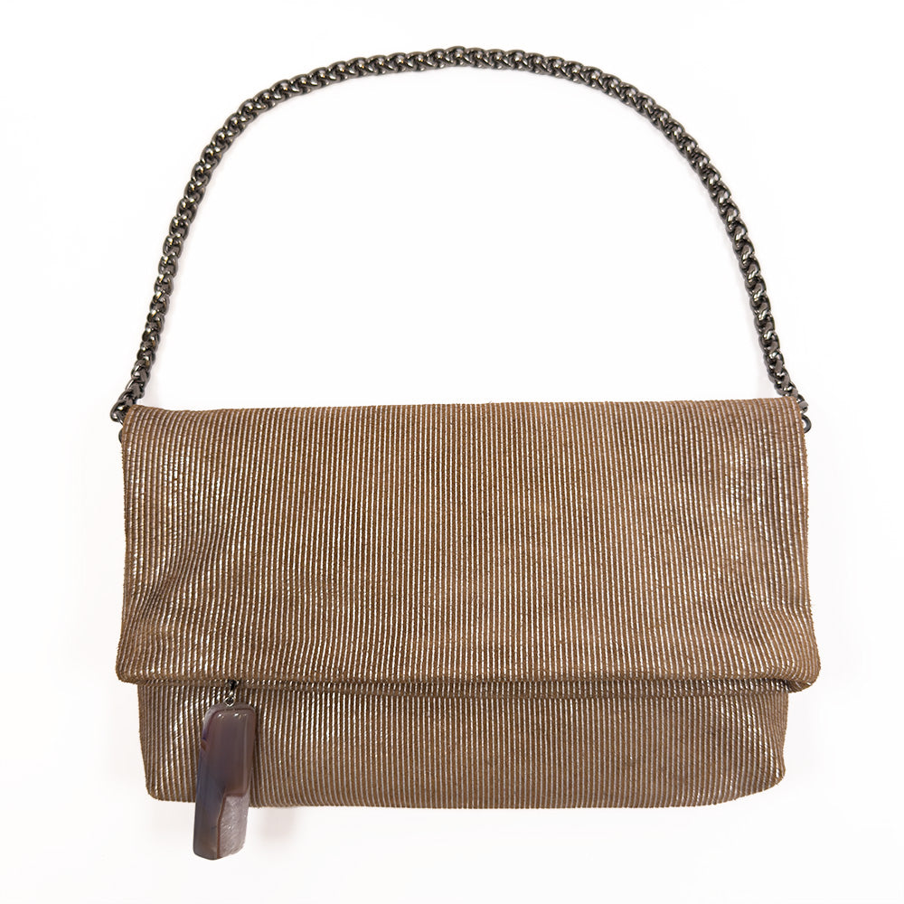 The Farah - nutshell-silver by evokewomen is a versatile accessory that showcases a brown textured design, elegantly highlighted with a snake spine chain and a decorative tassel in the front.