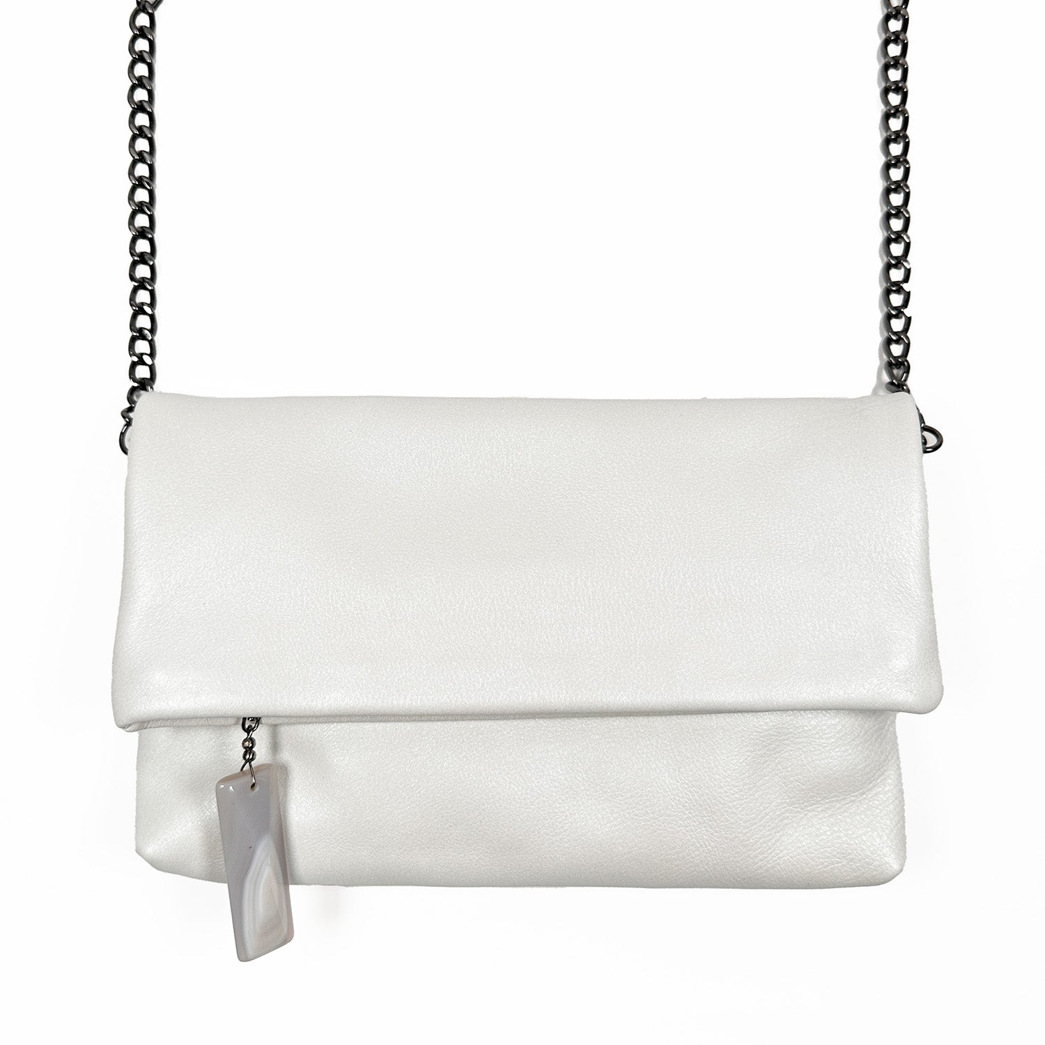 The Farah - pearl white clutch by evokewomen showcases a multifunctional design with smooth white leather, a flap closure, chain strap, and an attached rectangular keychain accented with a stone zipper charm.