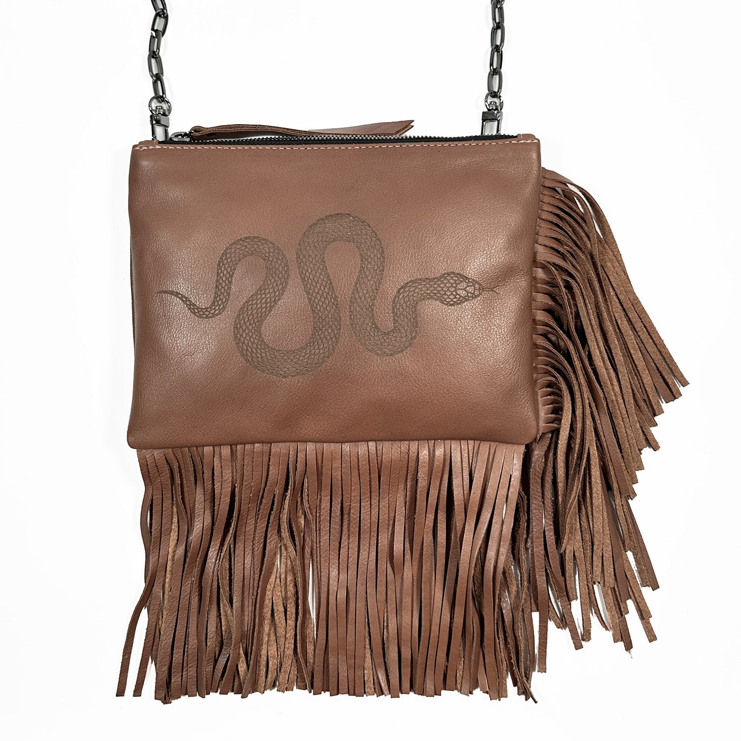 Get festival-ready with the Fringe bag - nutshell laser snake from evokewomen. This stylish brown leather bag showcases a captivating snake design on the front and includes an elegant chain strap, making it perfect for adding bohemian flair to any outfit.