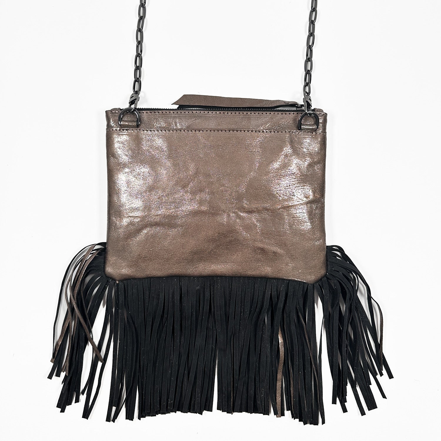 Backside of brown metallic fringe bag with zipper closure on white background. Gunmetal cross-body chain.