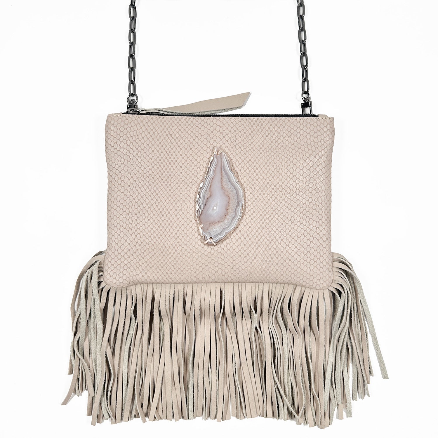 Powder hued snake embossed cross-body bag with zipper closure, fringes at bottom, and oval grey/white agate on white background. Gunmetal cross-body chain.