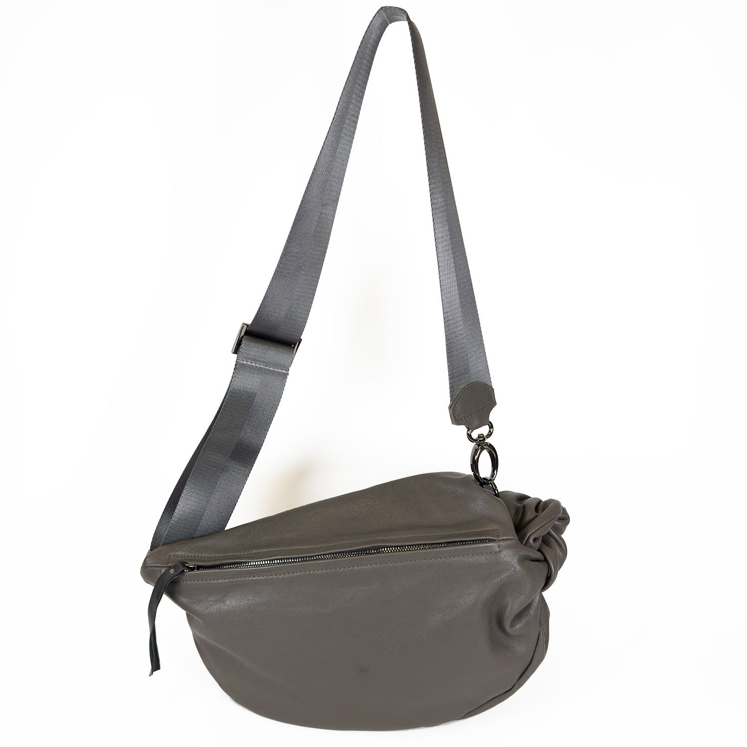 Introducing the LULA - OLIVE-GREY by evokewomen: A stylish olive-grey leather sling bag with an adjustable strap and a handy front zipper pocket.