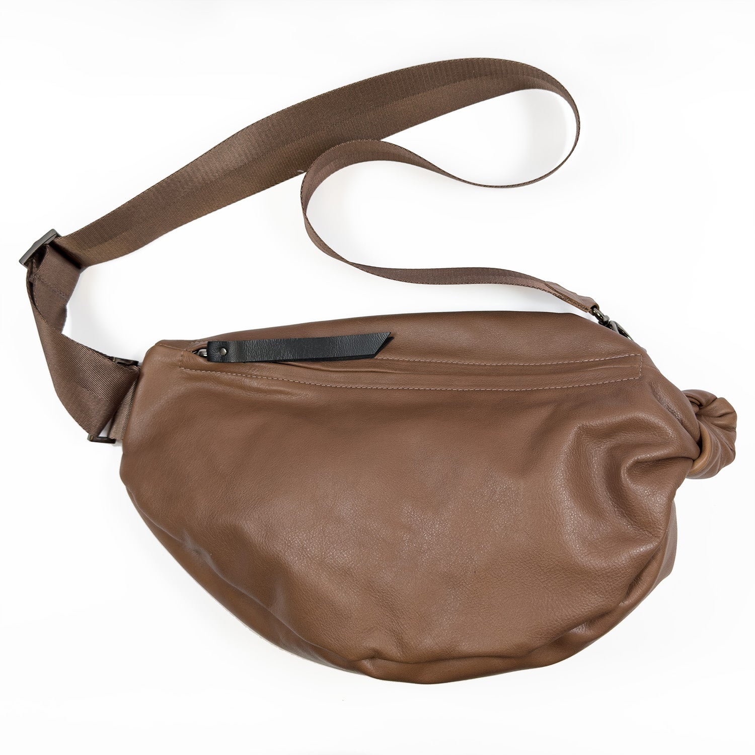 Introducing the LULA - NUTSHELL by evokewomen: a brown leather crossbody bag featuring an adjustable strap and a front zipper, designed as a chic sling bag for everyday use.