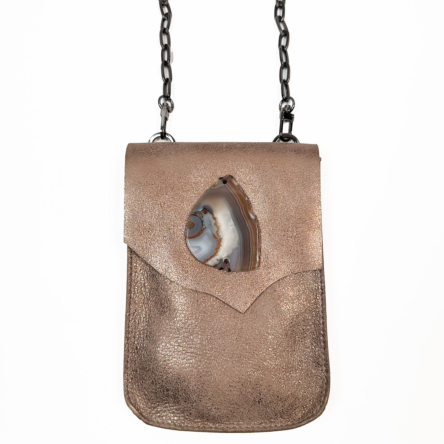 The PAULINA - antique bronze crossbody bag by evokewomen is a compact, rectangular accessory made from Italian leather. It includes a shoulder chain and features a decorative stone on the front flap, making it a must-have for festivals.