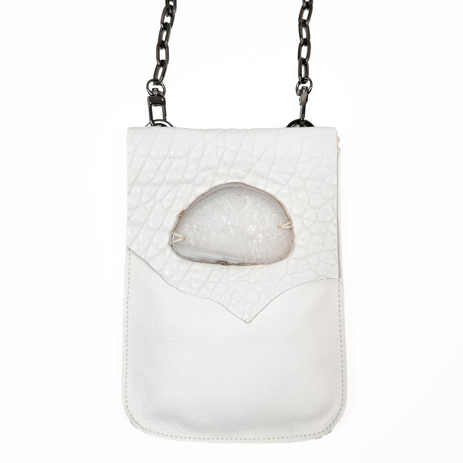 The PAULINA - white cross body bag by evokewomen boasts a chain strap and is adorned with a almond-shaped translucent stone detail on the flap.