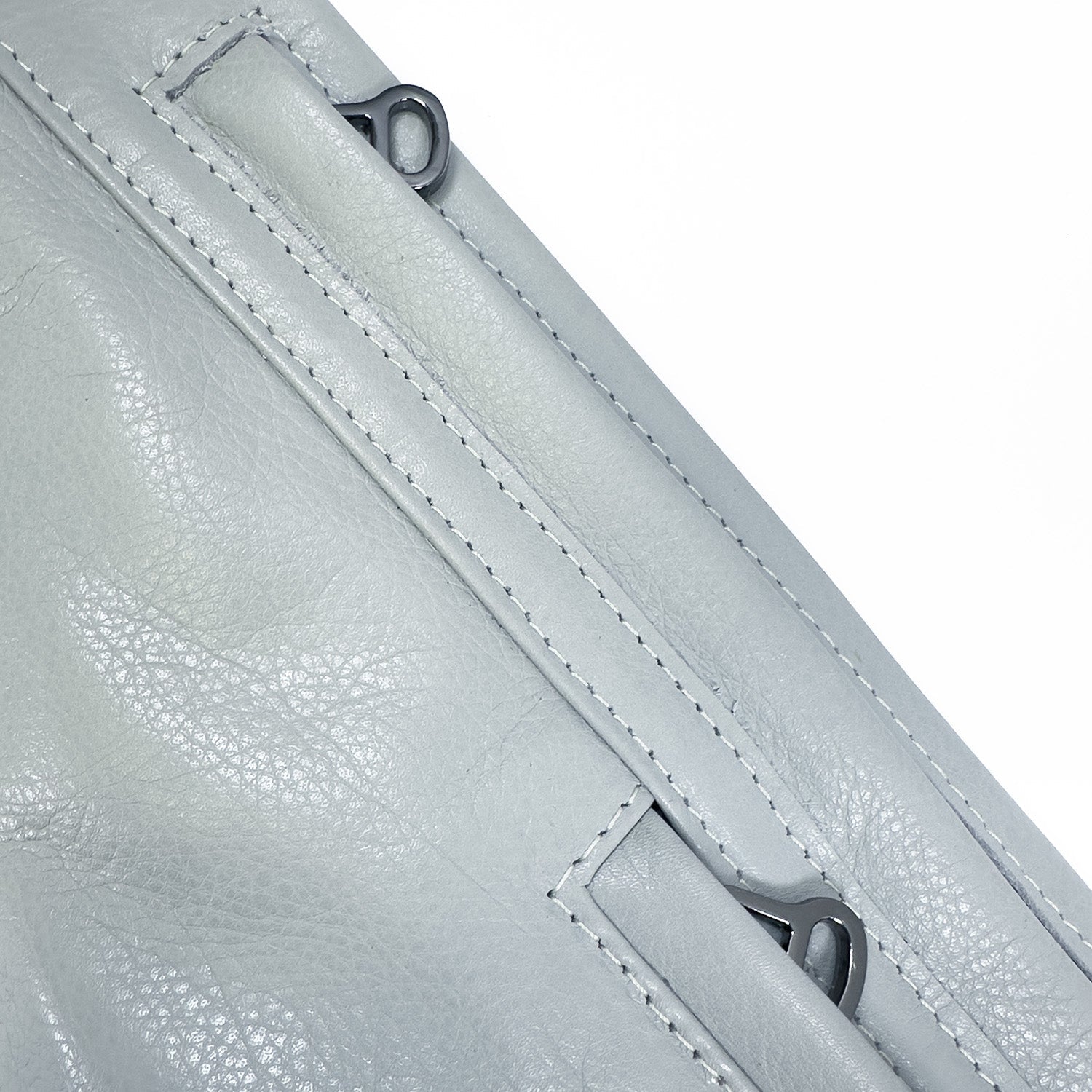Close-up of the Sienna - light smoke & tassel sling bag by evokewomen, featuring detailed stitching and two black metal rings, highlighting its versatile design.