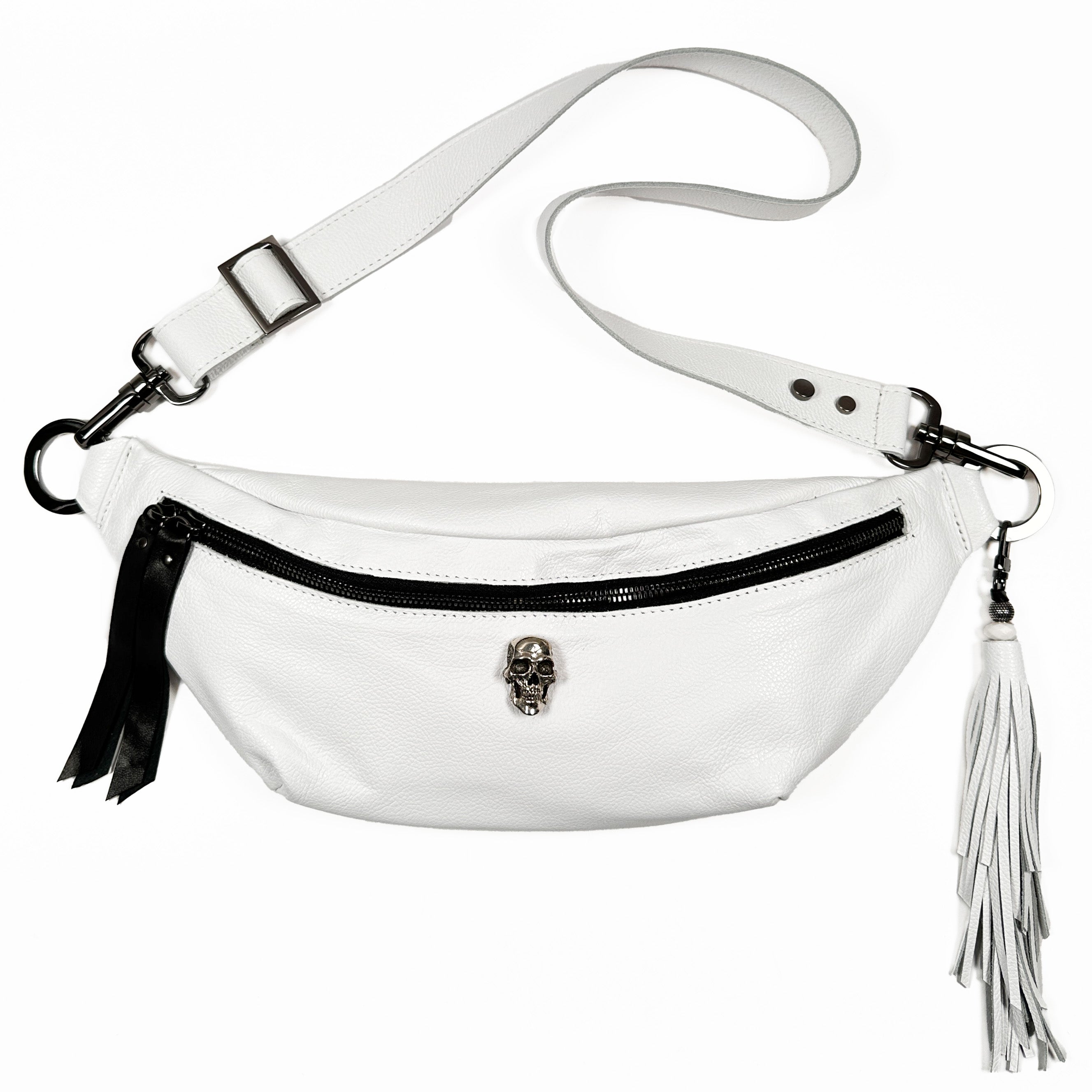 Introducing the STELLA - white - skull by evokewomen: a stylish Italian leather belt bag adorned with a sleek black zipper, striking skull detail, and a detachable tassel.