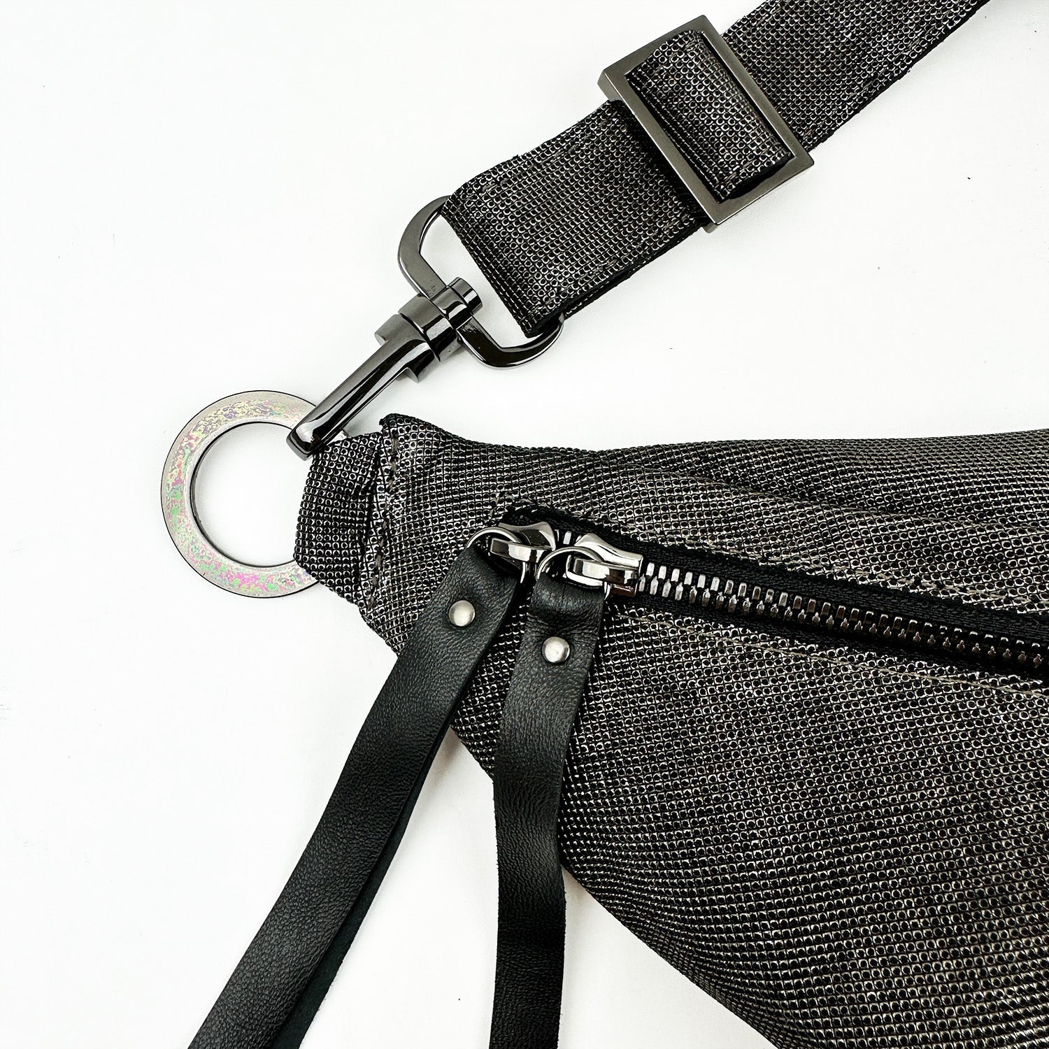 The "STELLA - GUNMETAL TEXTURE" by evokewomen is displayed against a white background, featuring a textured fabric cross body design with a metal buckle strap, silver zipper, and black leather pulls.