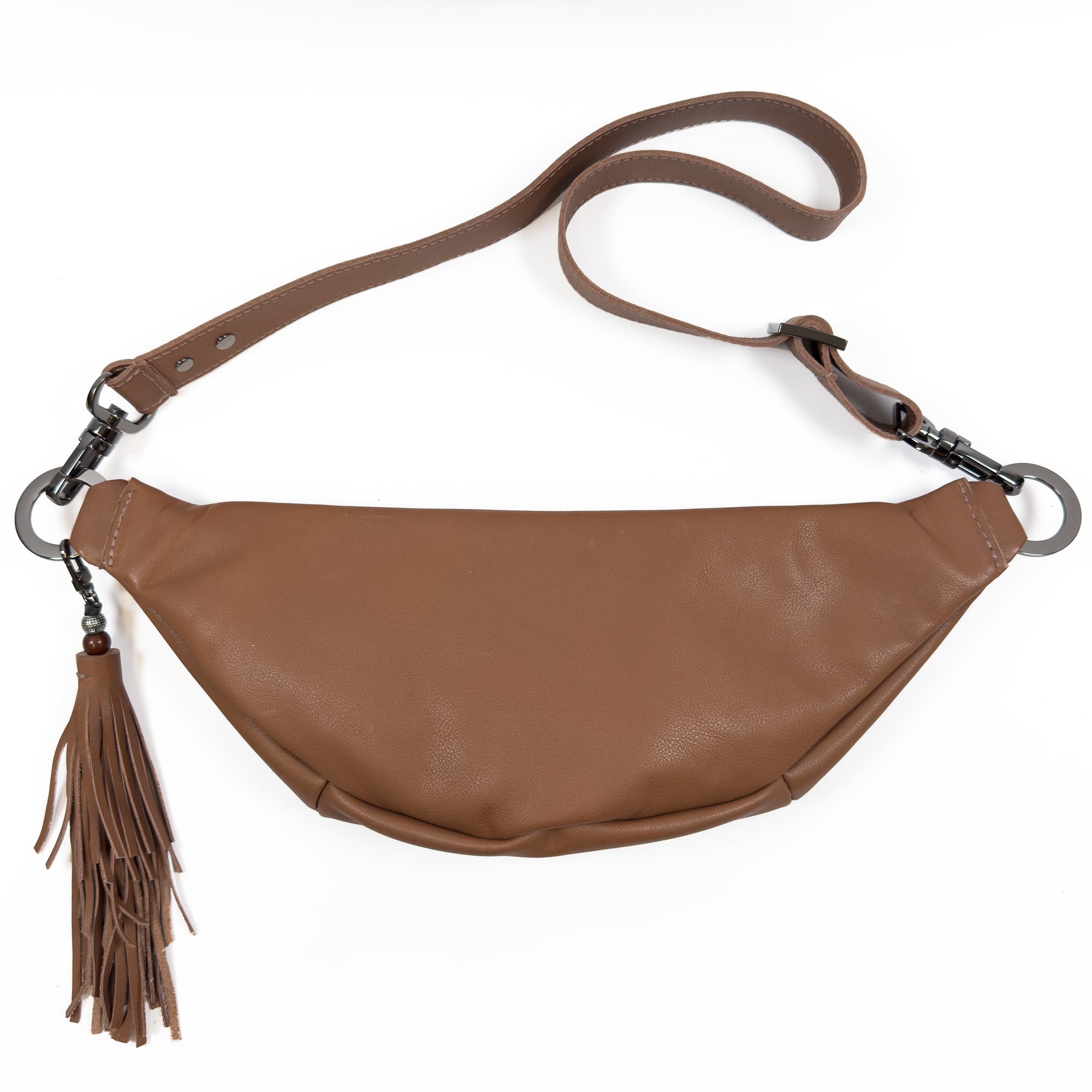 The STELLA - western brown by evokewomen is a chic brown leather sling bag featuring a tassel detail and adjustable strap, set against a white background. This stylish piece enhances your collection of fashion accessories with a touch of elegance.