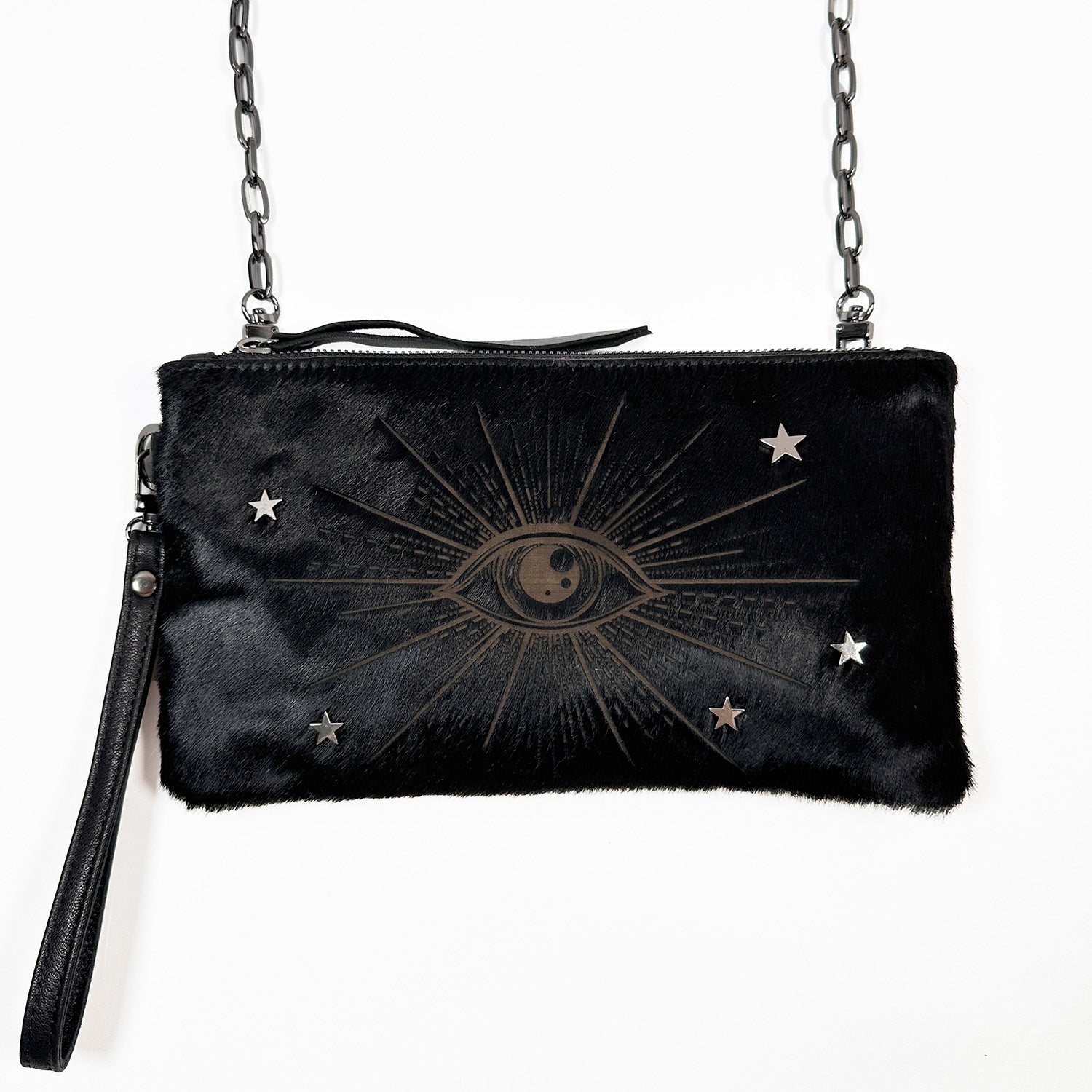 Introducing the VICTORIA clutch by evokewomen in elegant black with a laser eye design, featuring a versatile chain strap that makes it perfect for use as both a wristlet and a crossbody bag.