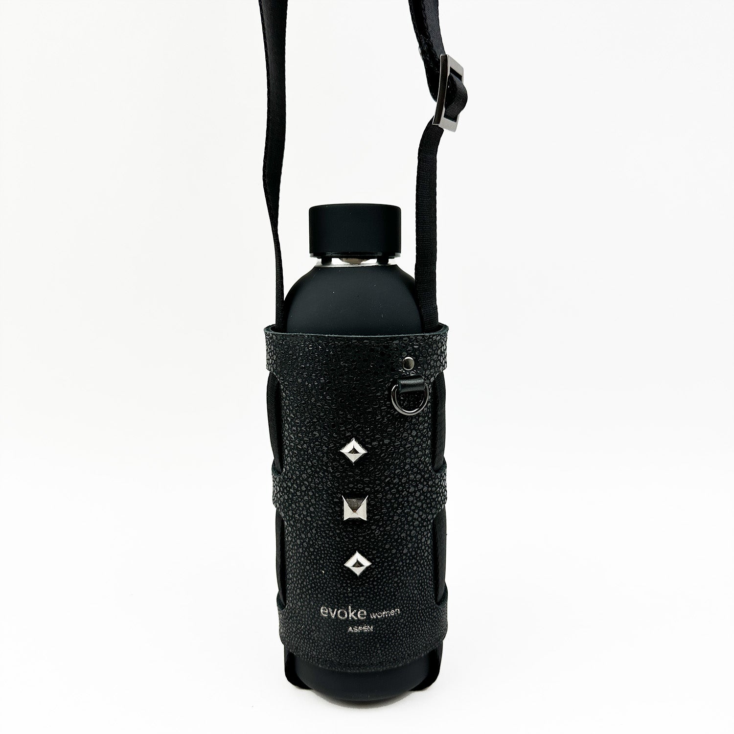 The Bottle Carrier - black Stingray by evokewomen features a textured, studded faux Stingray leather sleeve with an adjustable shoulder strap and buckle, perfect for holding your water bottle.