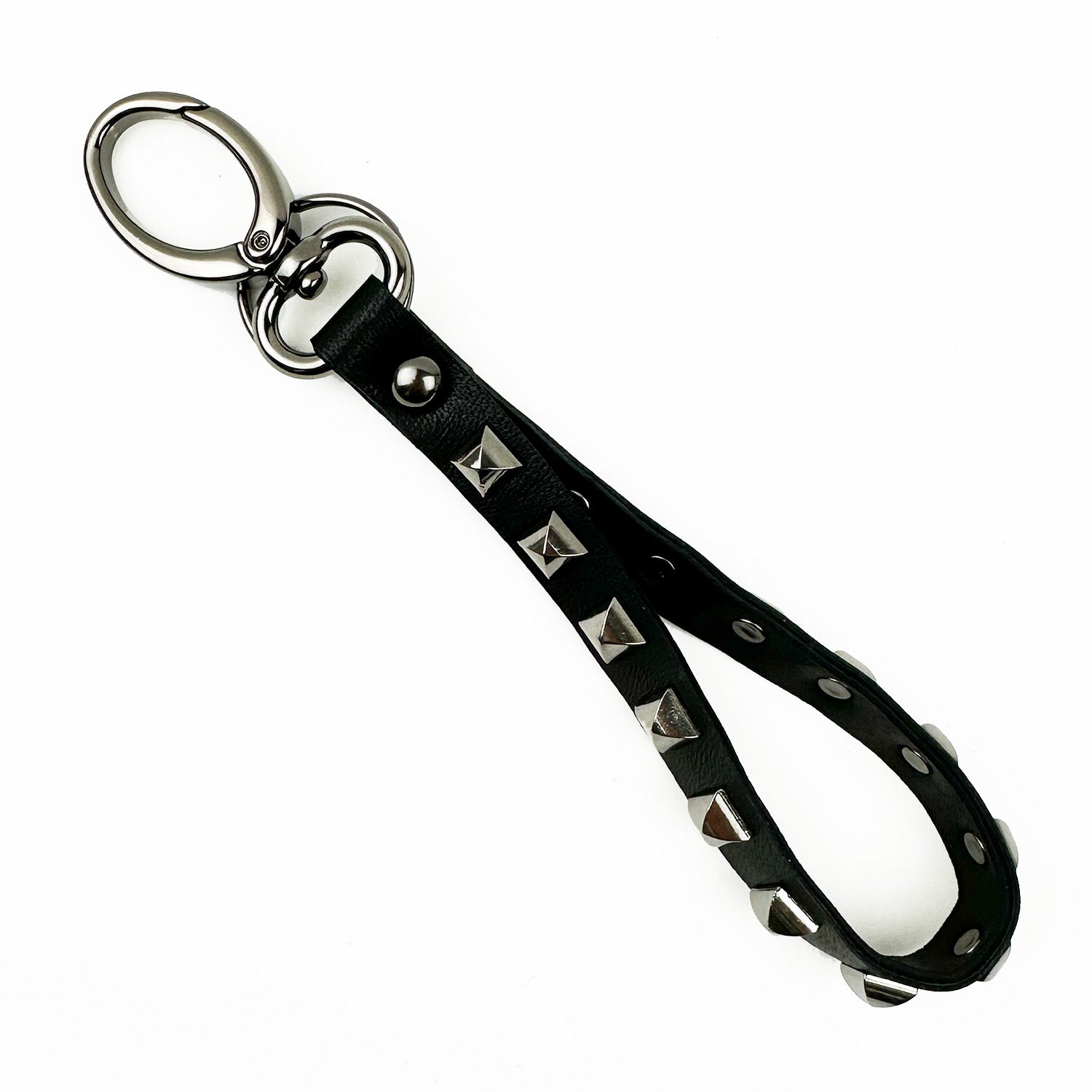 Introducing the KEY RING - BLACK PYRAMID RIVETS by evokewomen, a stylish black leather keychain featuring distinctive pyramid rivets and metal rings for easy attachment, making it the perfect accessory for carrying your keys.