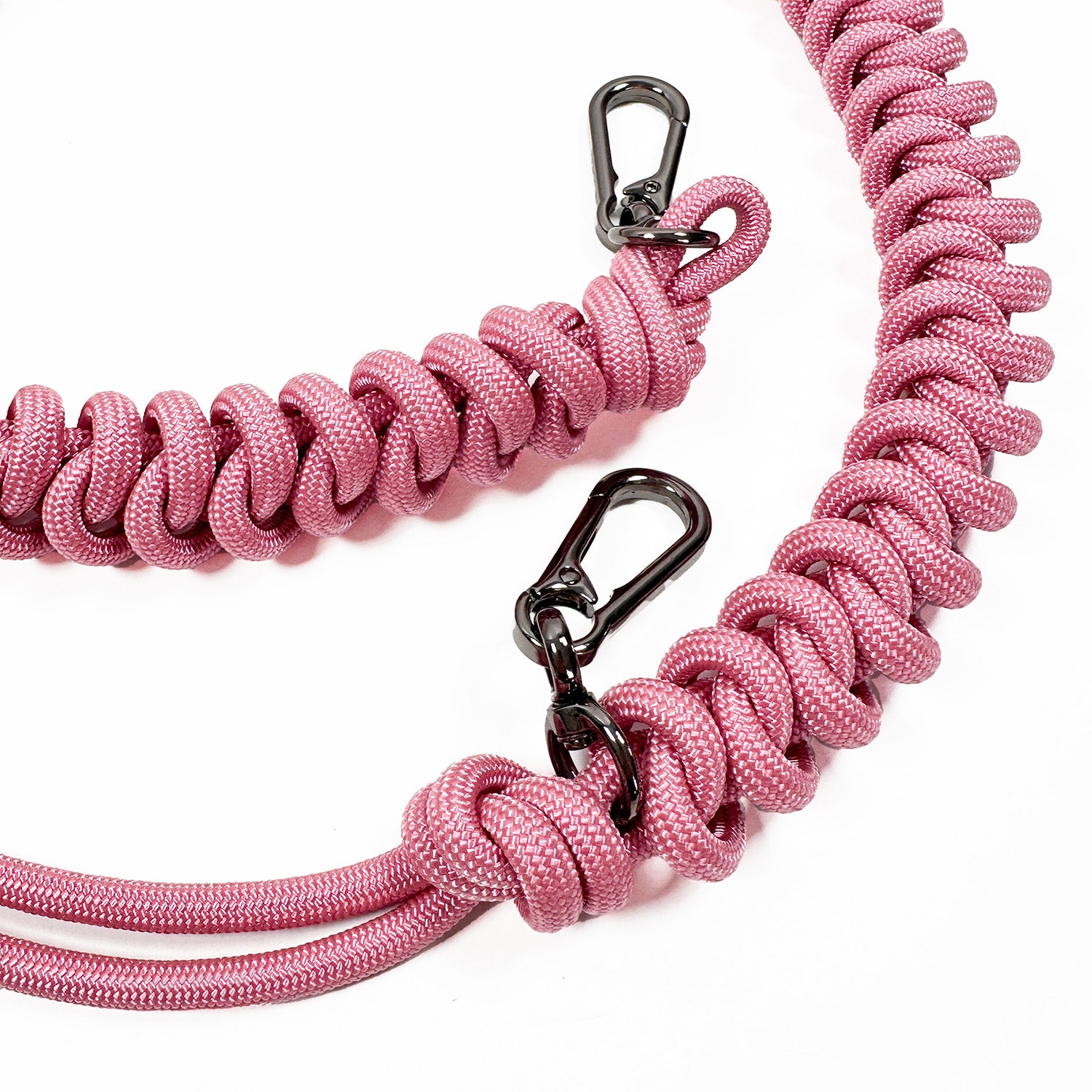 Detail of pink knotted paracord strap with 2 high end gunmetal colored swivel hooks on white background.
