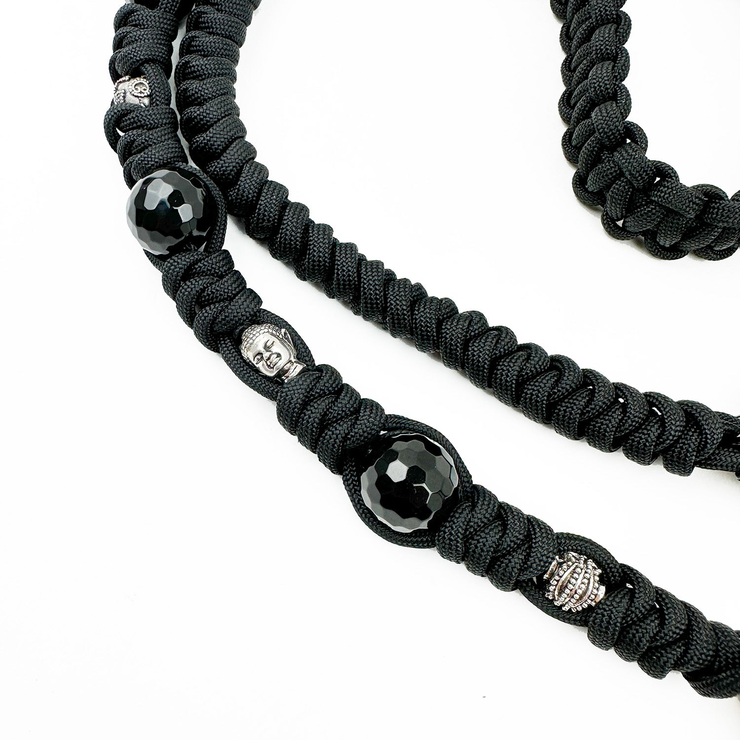 The KNOTTED SHOULDER STRAP - BLACK by evokewomen features black braided cords adorned with glossy black beads and black Agate, highlighted by small silver metal figurine beads.