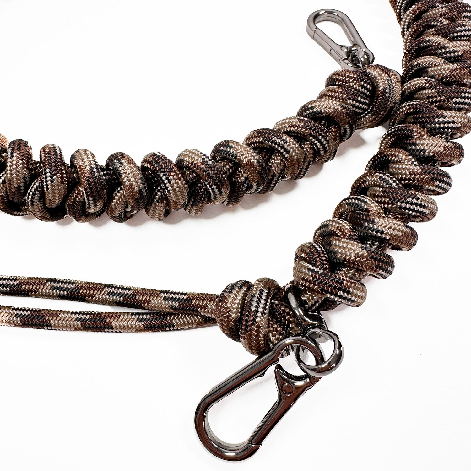 Detail of brown, beige, black knotted paracord strap with 2 high end gunmetal colored swivel hooks on white background.