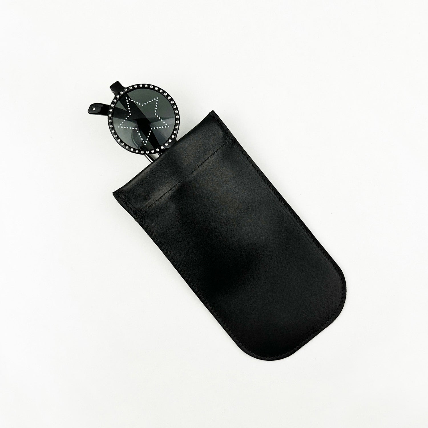 A distinctive design accessory from evokewomen, featuring a round, black star-shaped fan emerging from the sleek SUN-GLASS POUCH - BLACK.
