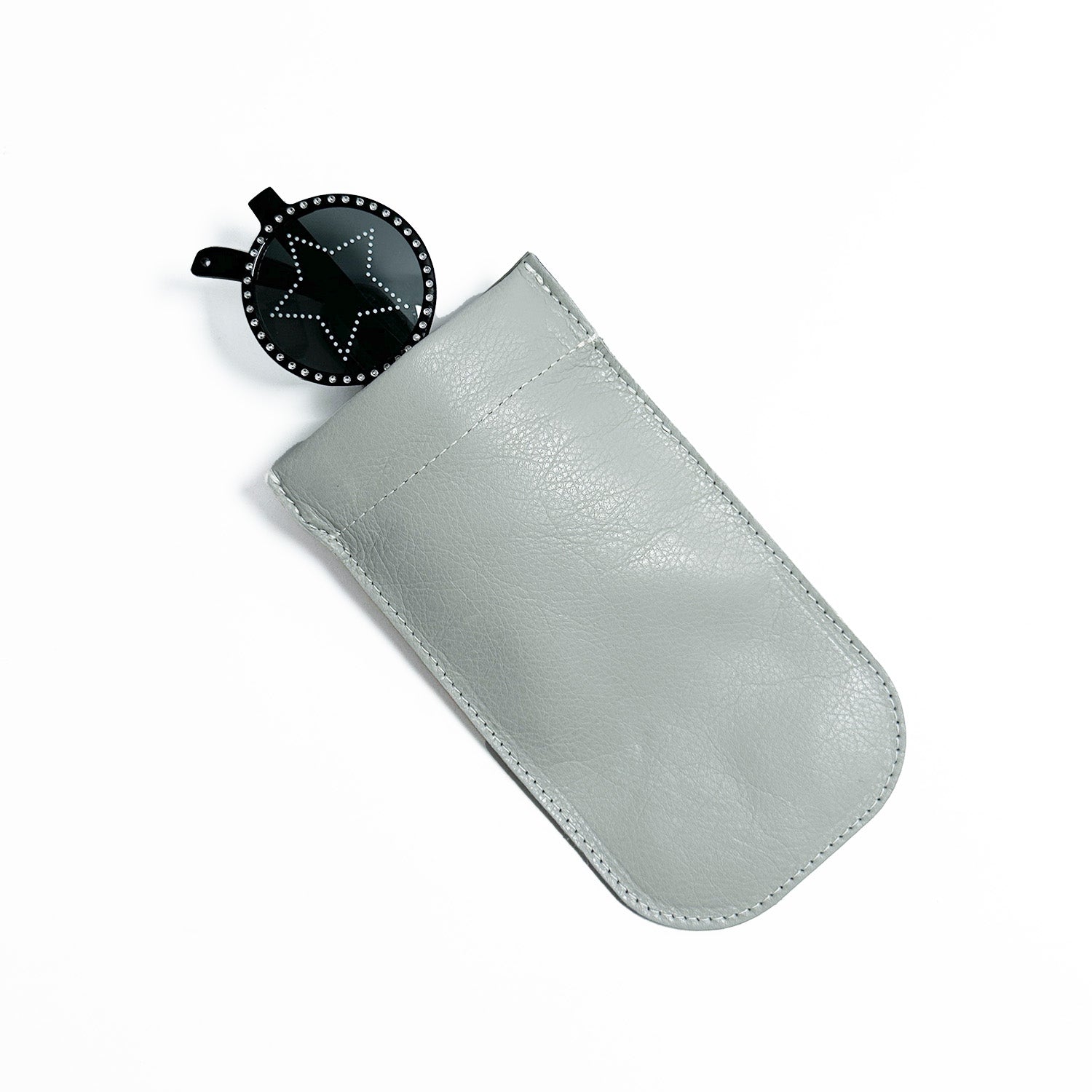 The SUN-GLASS POUCH - LIGHT SMOKE by evokewomen showcases a distinctive design, featuring a star-shaped keychain partially visible inside and offering an elegant solution for your eyewear needs.