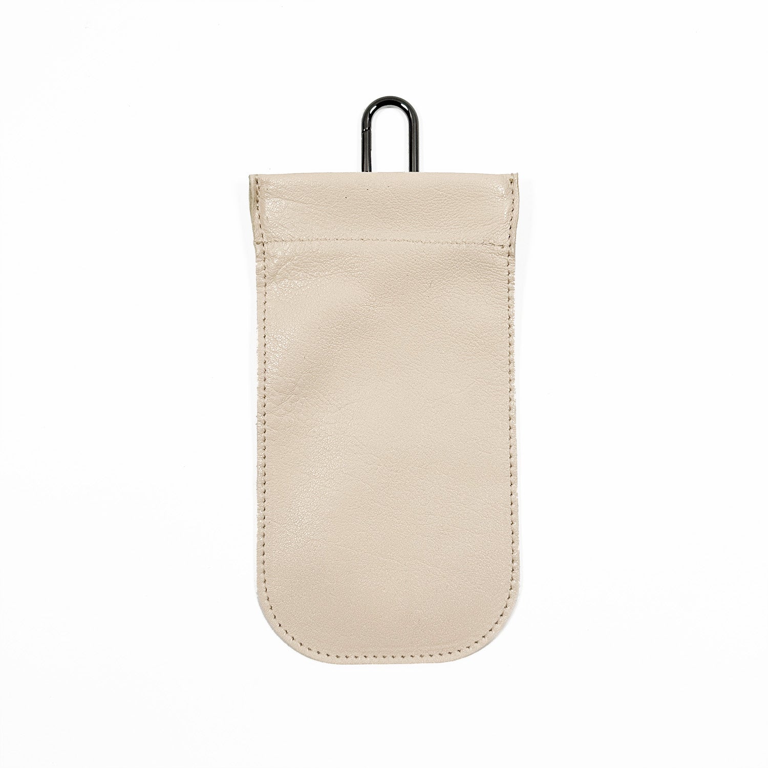 The SUN-GLASS POUCH - almond by evokewomen is a beige leather eyewear pouch featuring a squeeze frame closure and a black hook at the top, perfect for storing small items.