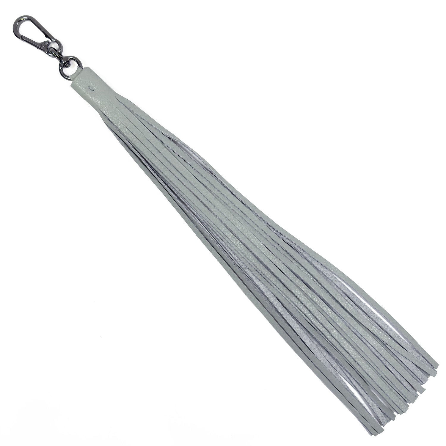 Introducing the TASSEL XXL in light smoke by evokewomen, a bold accessory crafted from white leather with an oversized tassel and a sleek metal clip, perfectly enhancing your gunmetal accessories collection.
