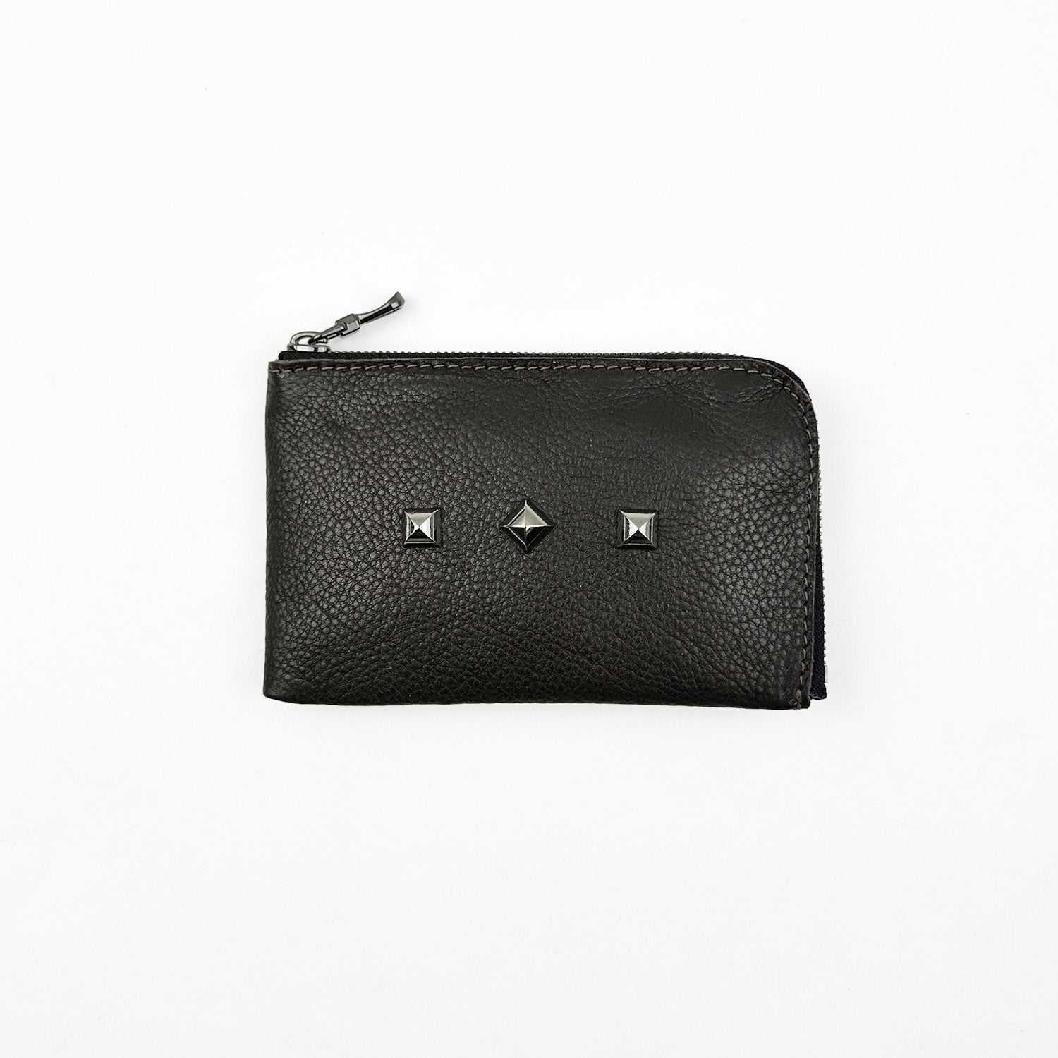 Discover the MINI WALLET - BROWN by evokewomen, featuring a unique design with three square metal studs on the front. Perfectly compact and stylish, this zippered accessory combines functionality with an edge.