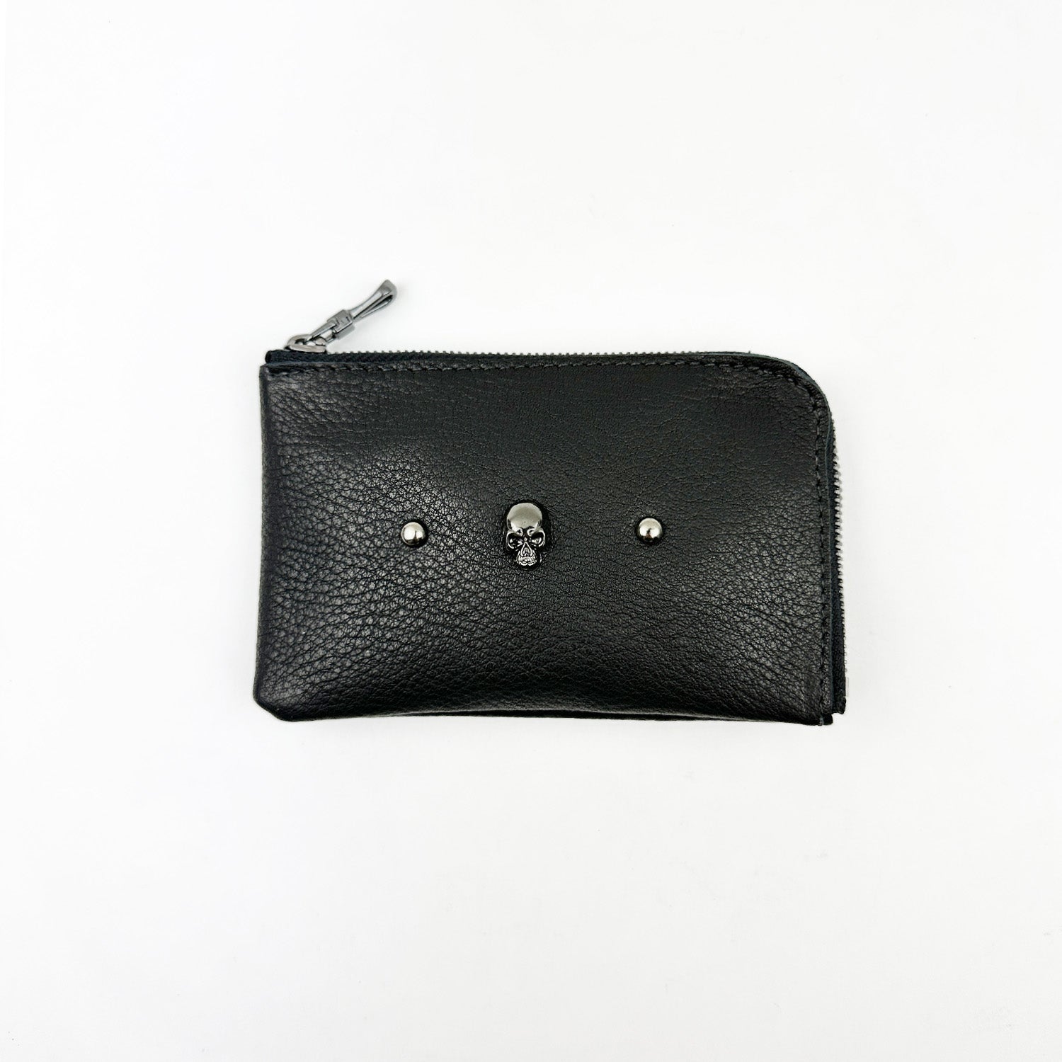 The evokewomen MINI WALLET - BLACK SKULL, showcasing a distinctive design with a small skull decoration and a zipper closure, is displayed on a white background.