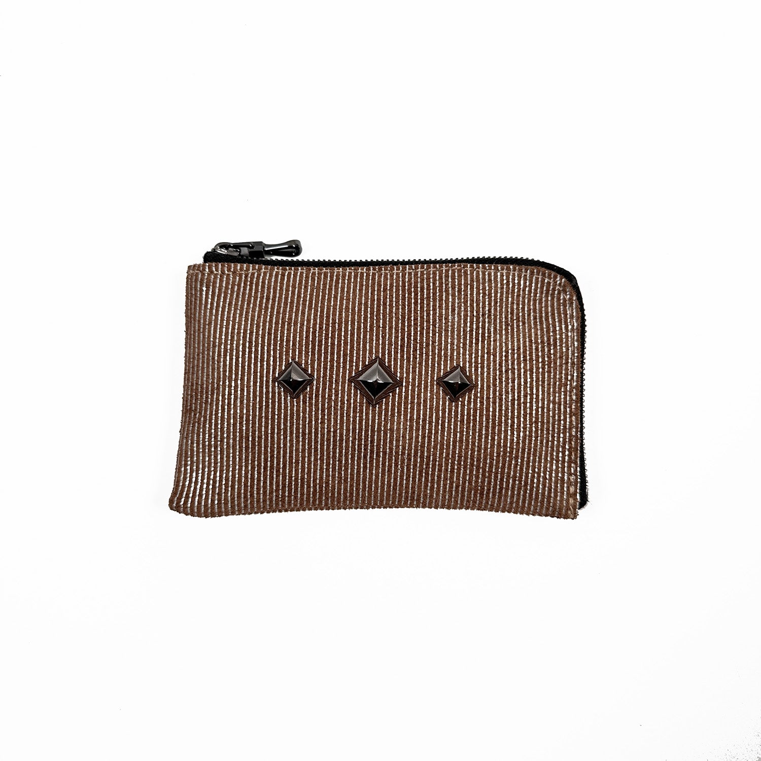 The MINI WALLET - nutshell-silver by evokewomen is a brown zippered pouch with a unique design, showcasing three black geometric studs on a white background and crafted from high-quality leather.