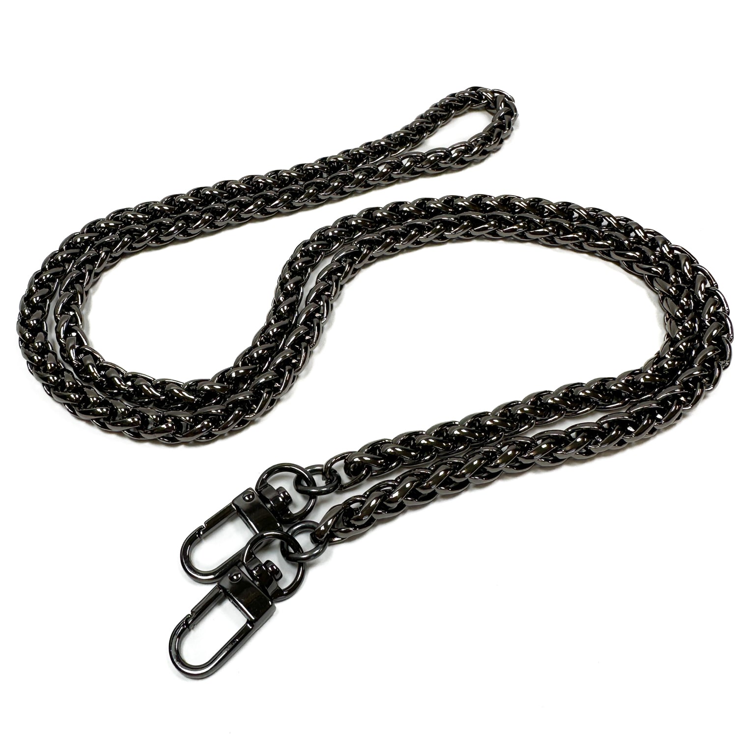 The SNAKE SPINE CHAIN - SHOULDER LENGTH by evokewomen features a twisted metal design with two swivel clasps at each end, coiled on a white background to evoke the elegance of a snake spine. This luxurious piece is a distinctive accessory that adds unique design elements to any wardrobe.