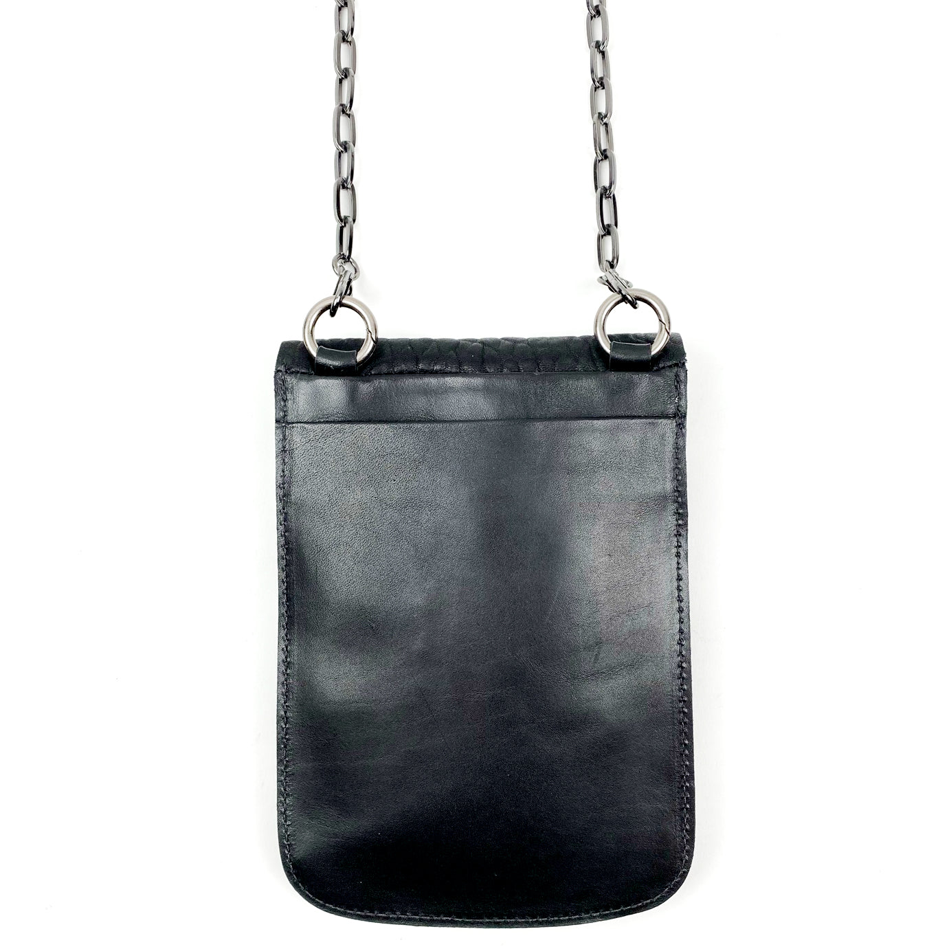 Introducing the PAULINA - BLACK by evokewomen, a black Italian leather pouch with a chain strap and two metal rings at the top. Set against a white background, this adaptable accessory can be styled as either a chic waist bag or an elegant crossbody bag for any occasion.