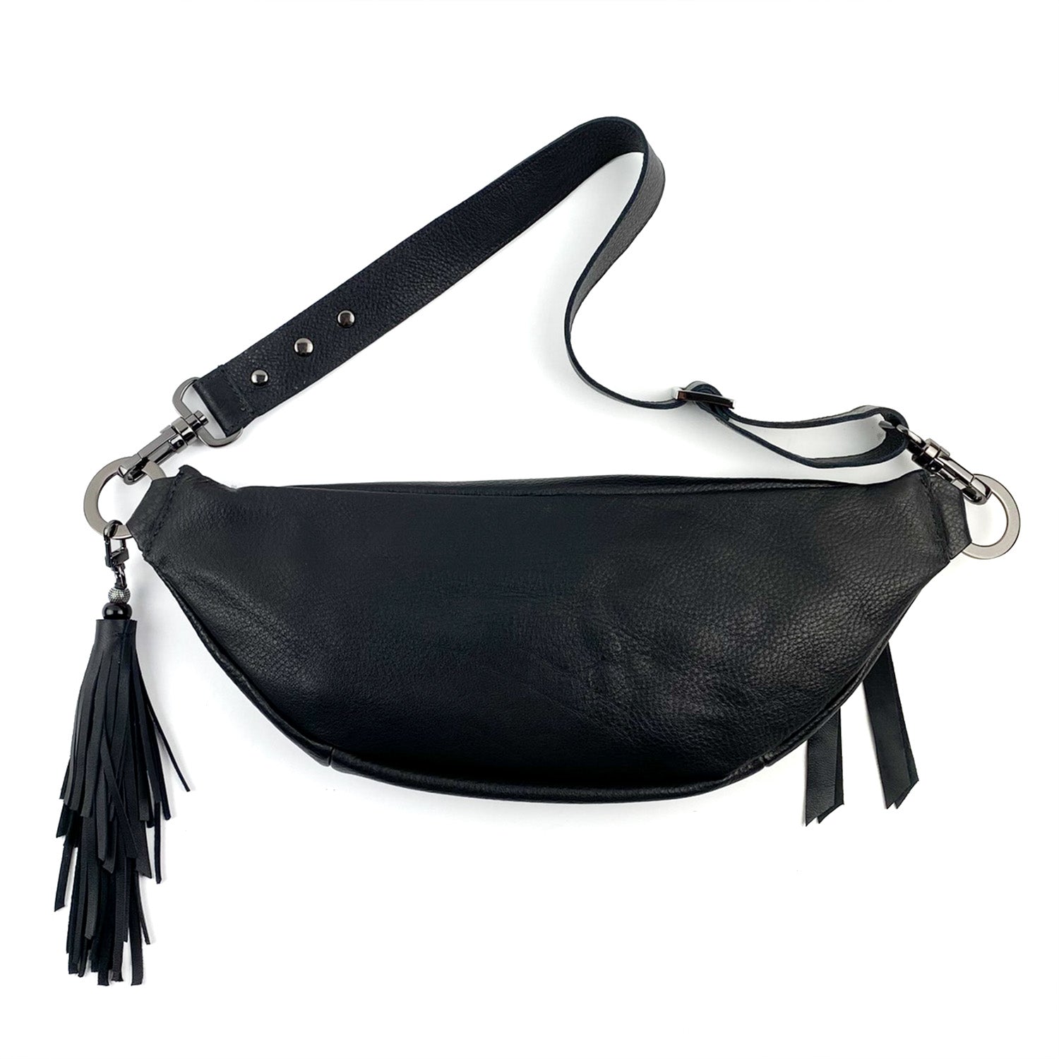 The STELLA - BLACK sling bag by evokewomen features a black leather design with a detachable strap and tassel detail on one side, providing versatile styling options.