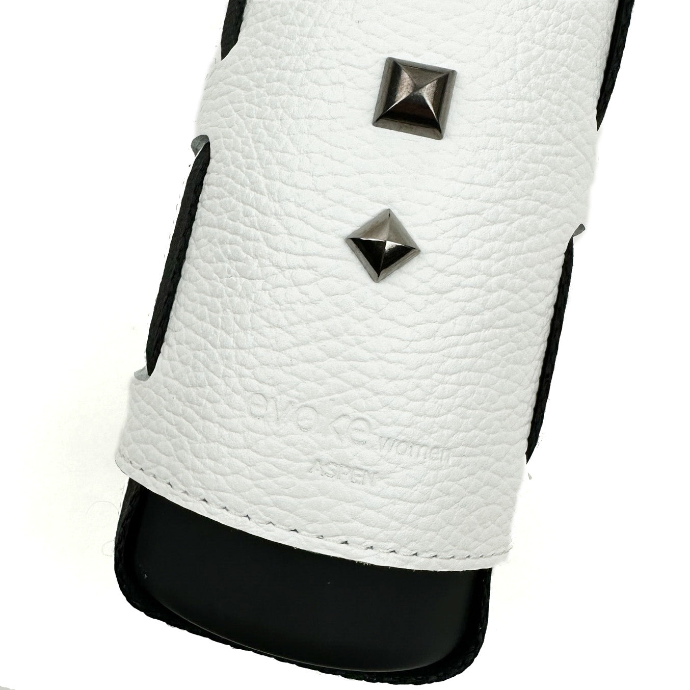Close-up of the evokewomen Bottle Carrier in white, showcasing a textured leather strap with two square metal studs and partially embossed text, finished with an adjustable shoulder strap for added convenience.
