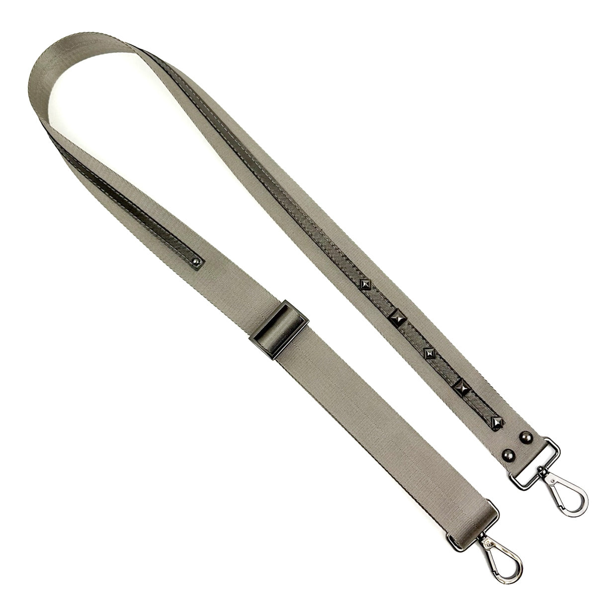 The SHOULDER STRAP - GREY-GREY by evokewomen, adorned with gunmetal accessories and decorative studs, adds a touch of elegance.