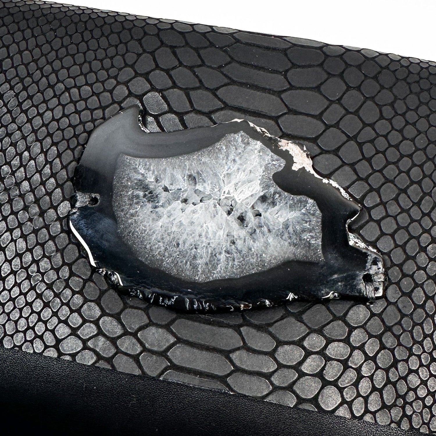 Introducing the BAHAMA – black snake look - shoulder bag by evokewomen, a versatile piece crafted from premium matte faux snake Italian leather adorned with a striking agate. This elegant bag is accented with a chic gunmetal chain strap and is beautifully showcased against a crisp white backdrop.