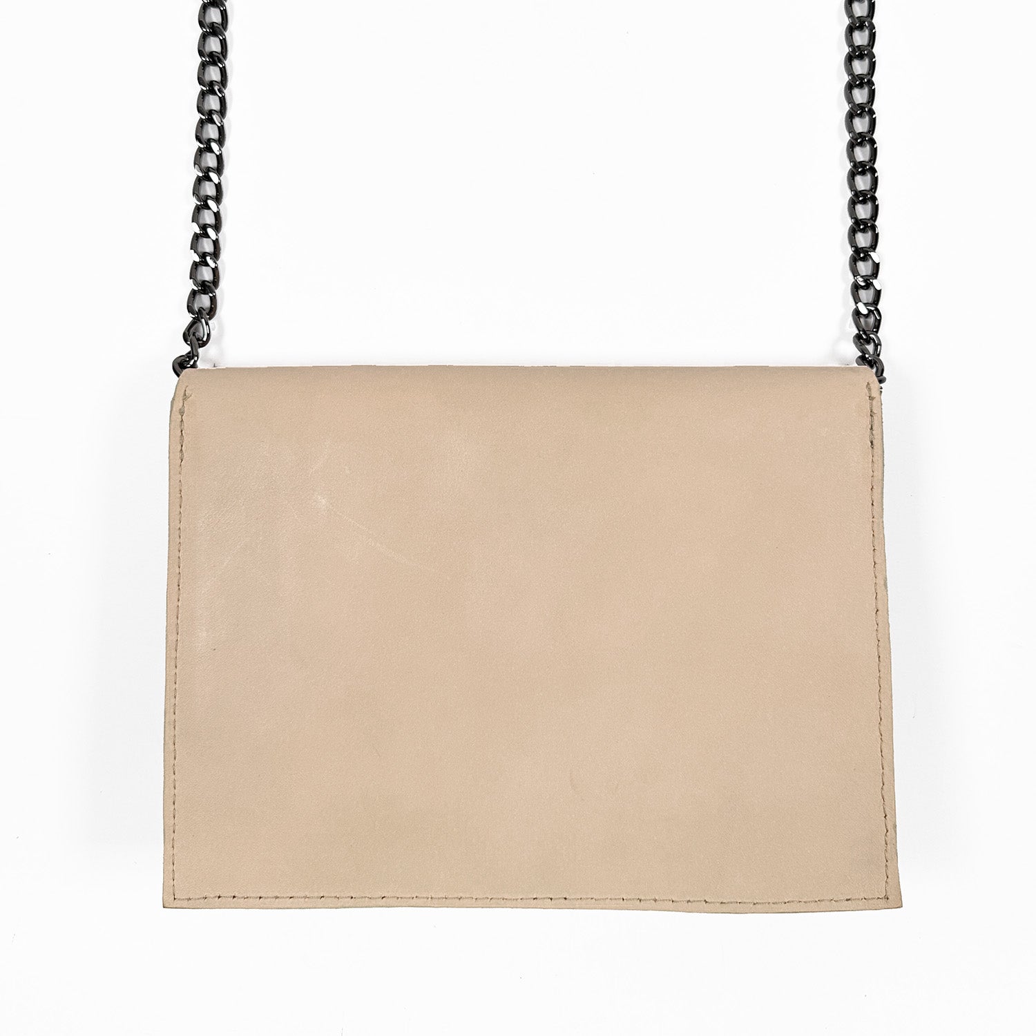 Backside of beige leather crossbody bag with a black gunmetal chain strap.