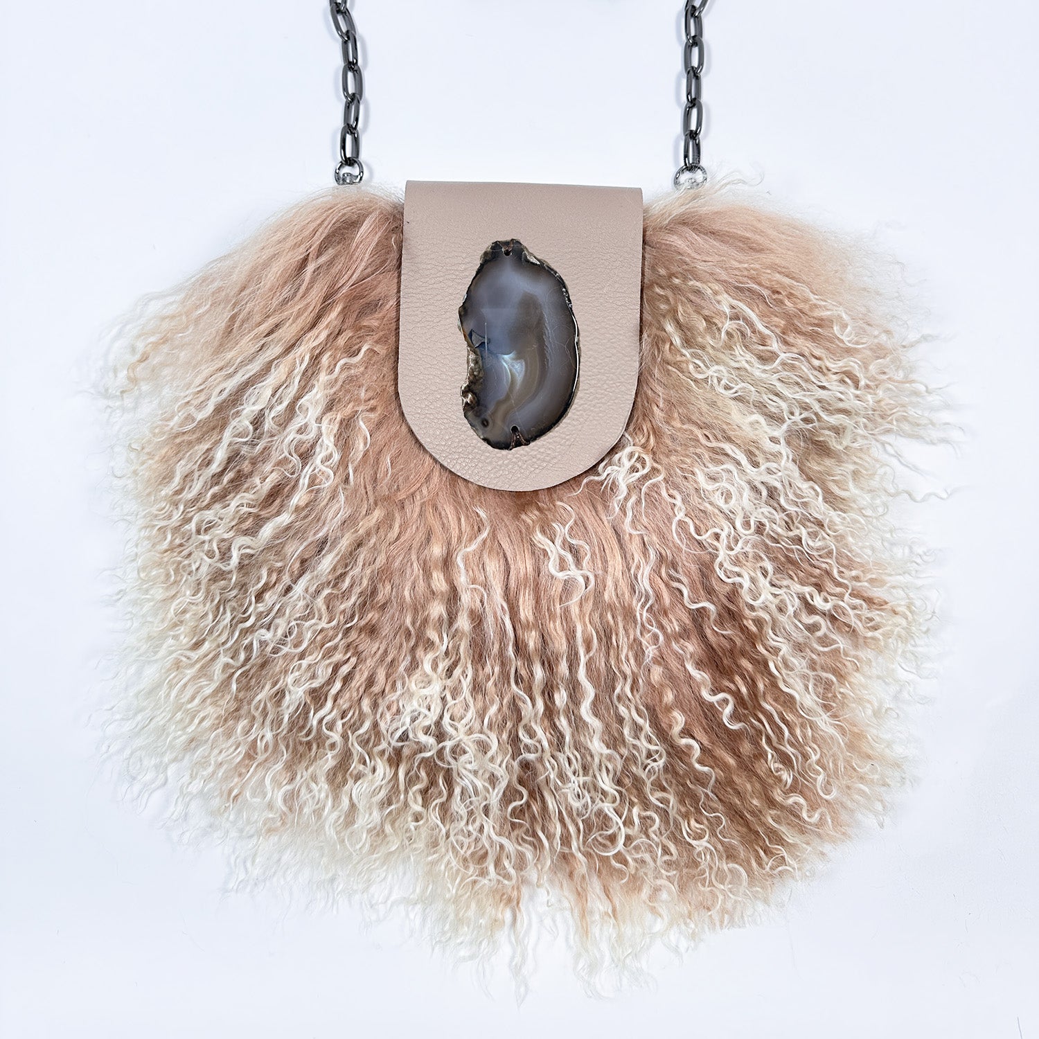 The MIA - BEIGE by evokewomen is a beige leather crossbody bag featuring luxurious Mongolian lamb fur trim and a fashionable chain shoulder strap, ideal for creating a chic statement.