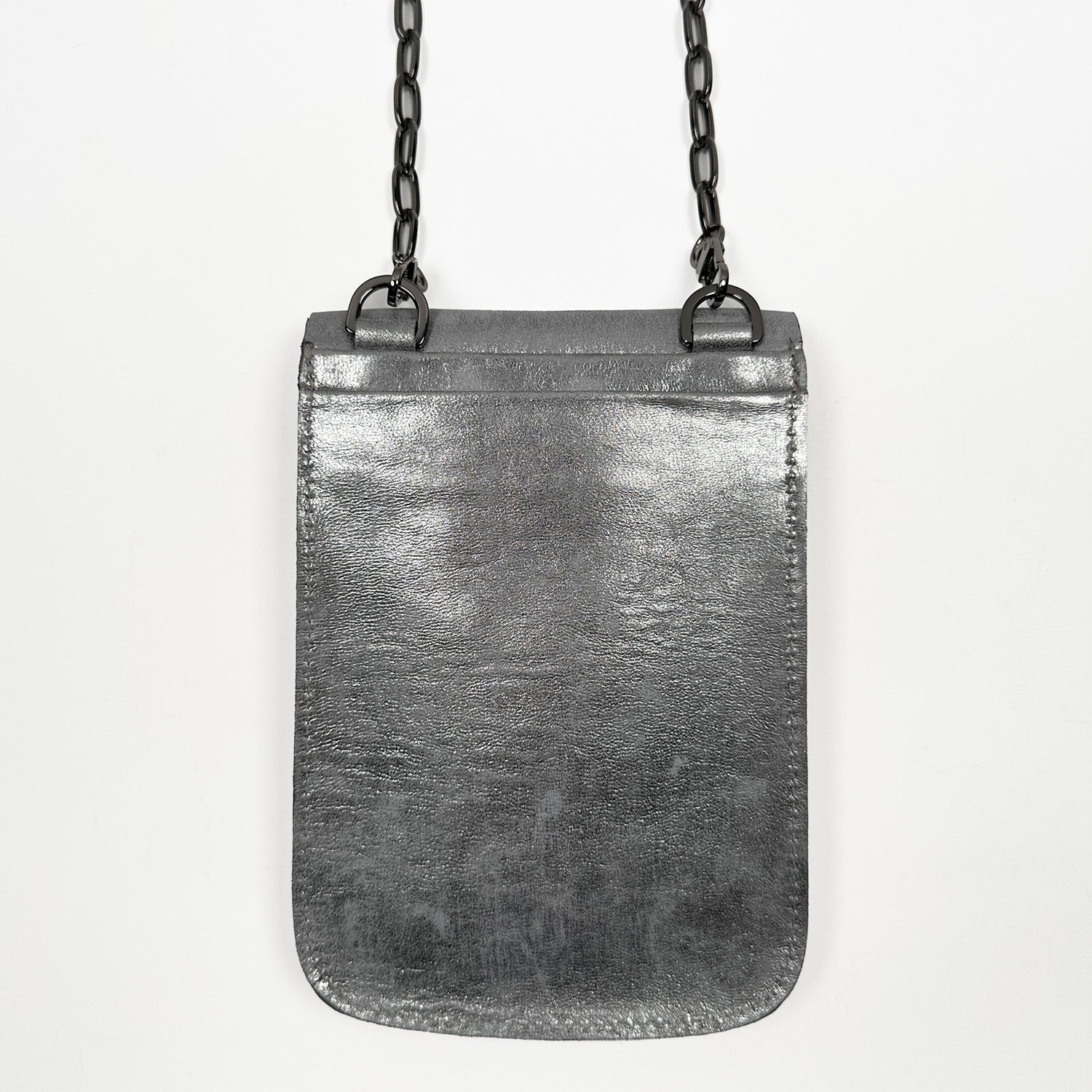 The PAULINA - ANTIQUE SILVER by evokewomen is a small rectangular crossbody bag made from sumptuous Italian leather, adorned with a chic gunmetal chain strap hanging elegantly against a pristine white background—a true festival essential.