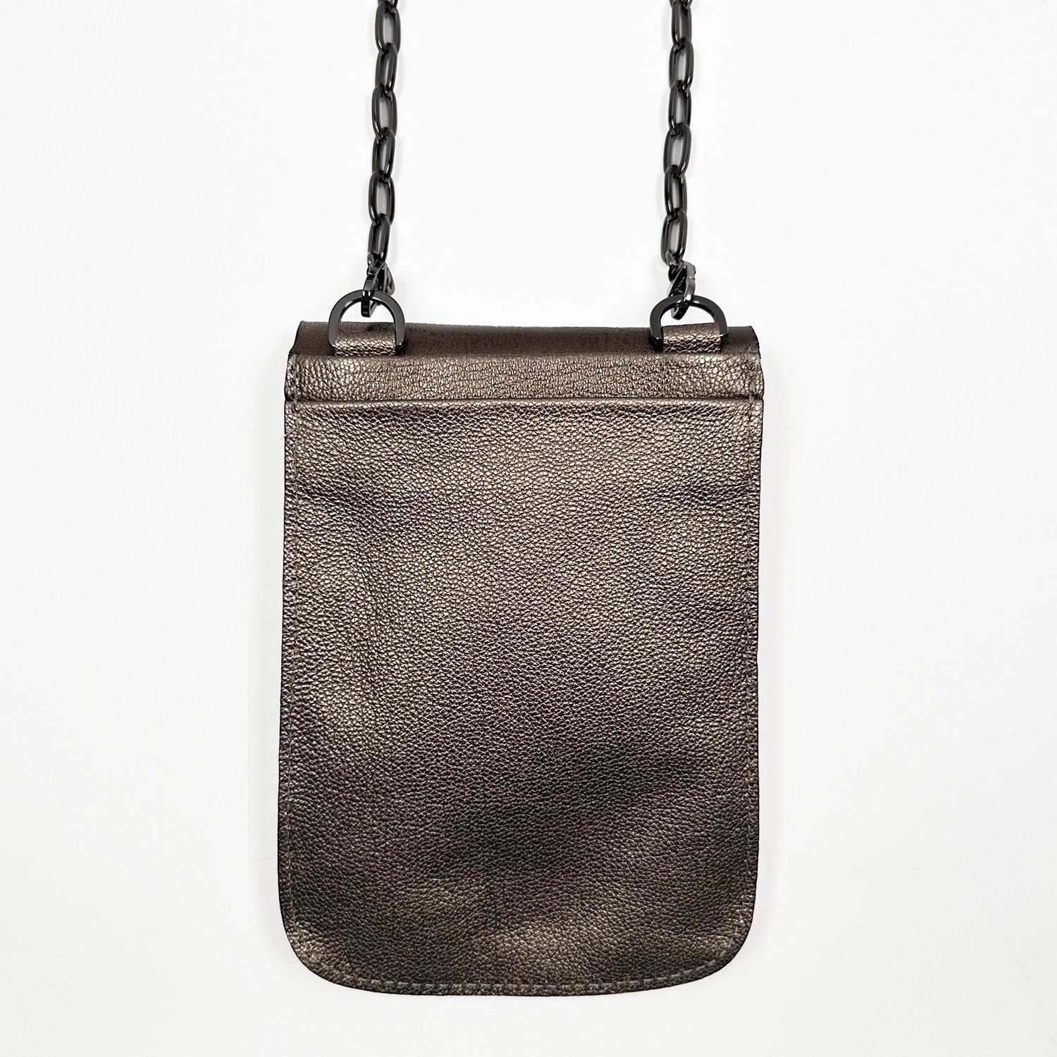 The PAULINA - BRONZE by evokewomen is a small rectangular crossbody bag made from sumptuous Italian leather, adorned with a chic gunmetal chain strap hanging elegantly against a pristine white background—a true festival essential.