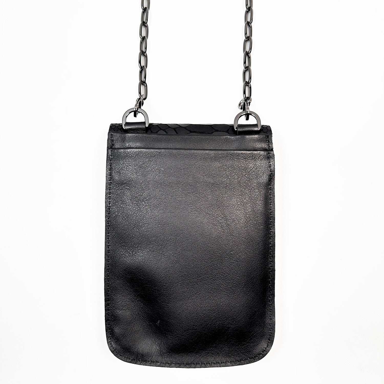 The PAULINA - BLACK SNAKE LOOK by evokewomen is a small rectangular crossbody bag made from black Italian leather, adorned with a chic gunmetal chain strap hanging elegantly against a pristine white background—a true festival essential.