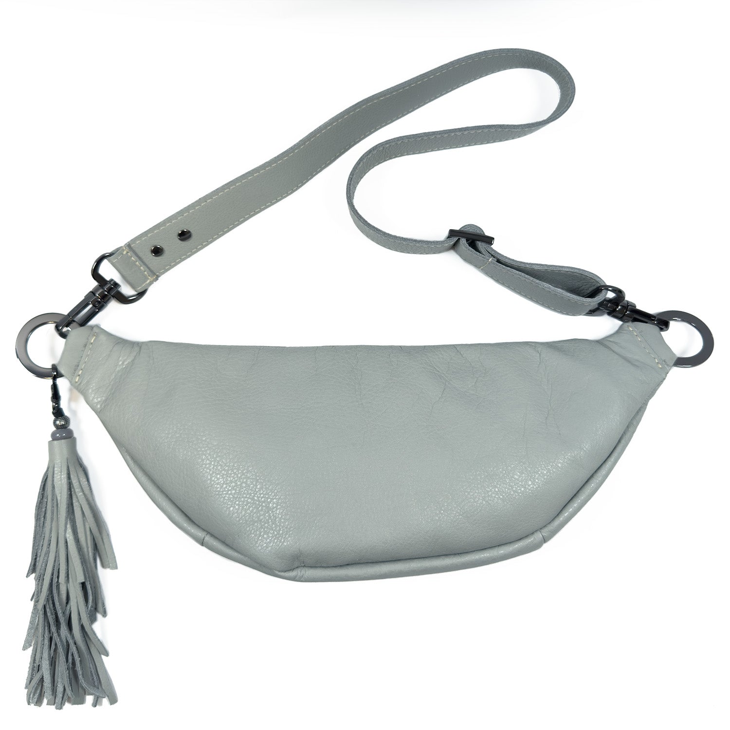 Introducing the STELLA - light smoke by evokewomen: a sophisticated light gray leather sling bag, designed with a detachable strap, rivet embellishments, and a tassel accent on one side.