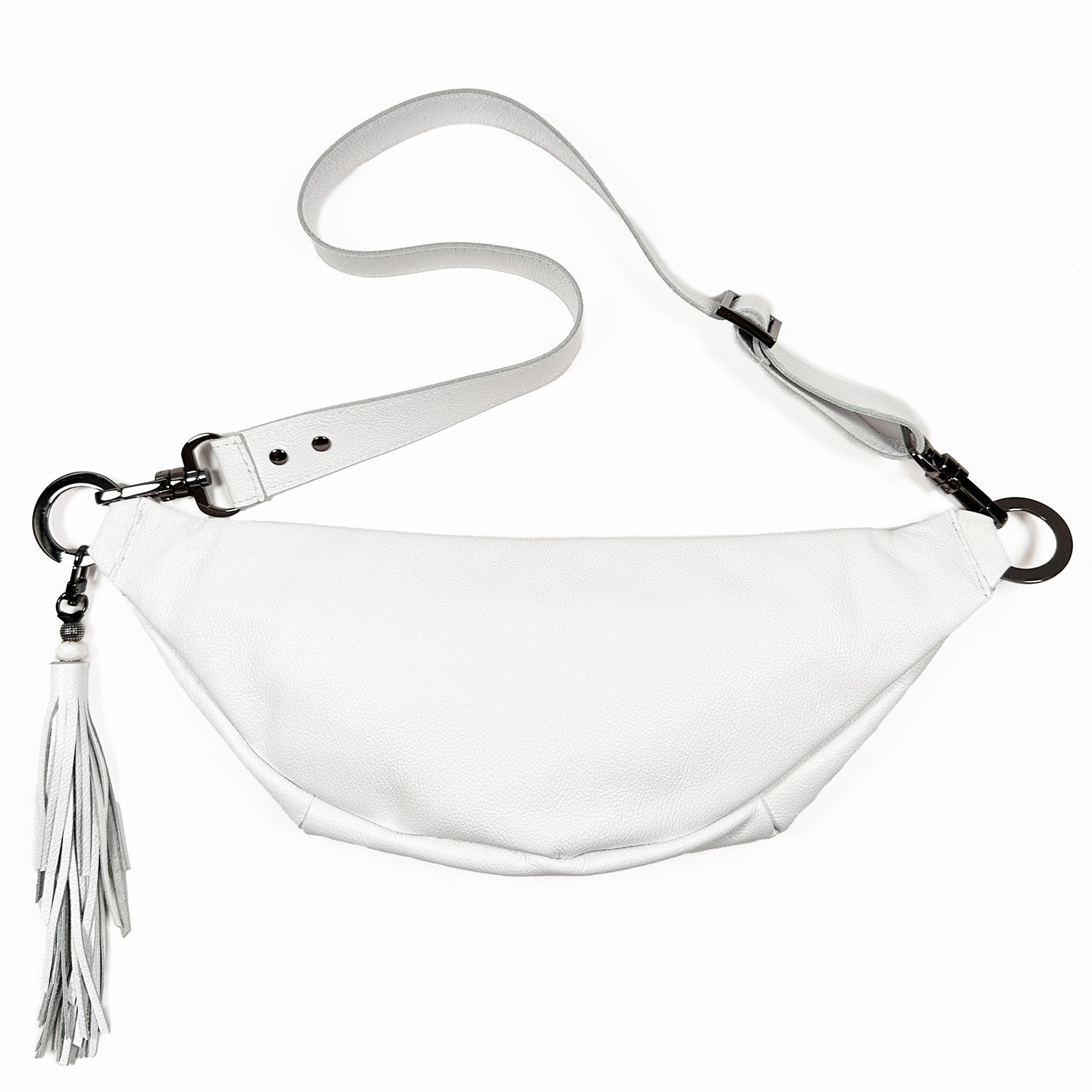 The STELLA - white - skull by evokewomen is a stylish sling bag made from premium Italian leather, complete with a detachable strap and a chic tassel accessory.