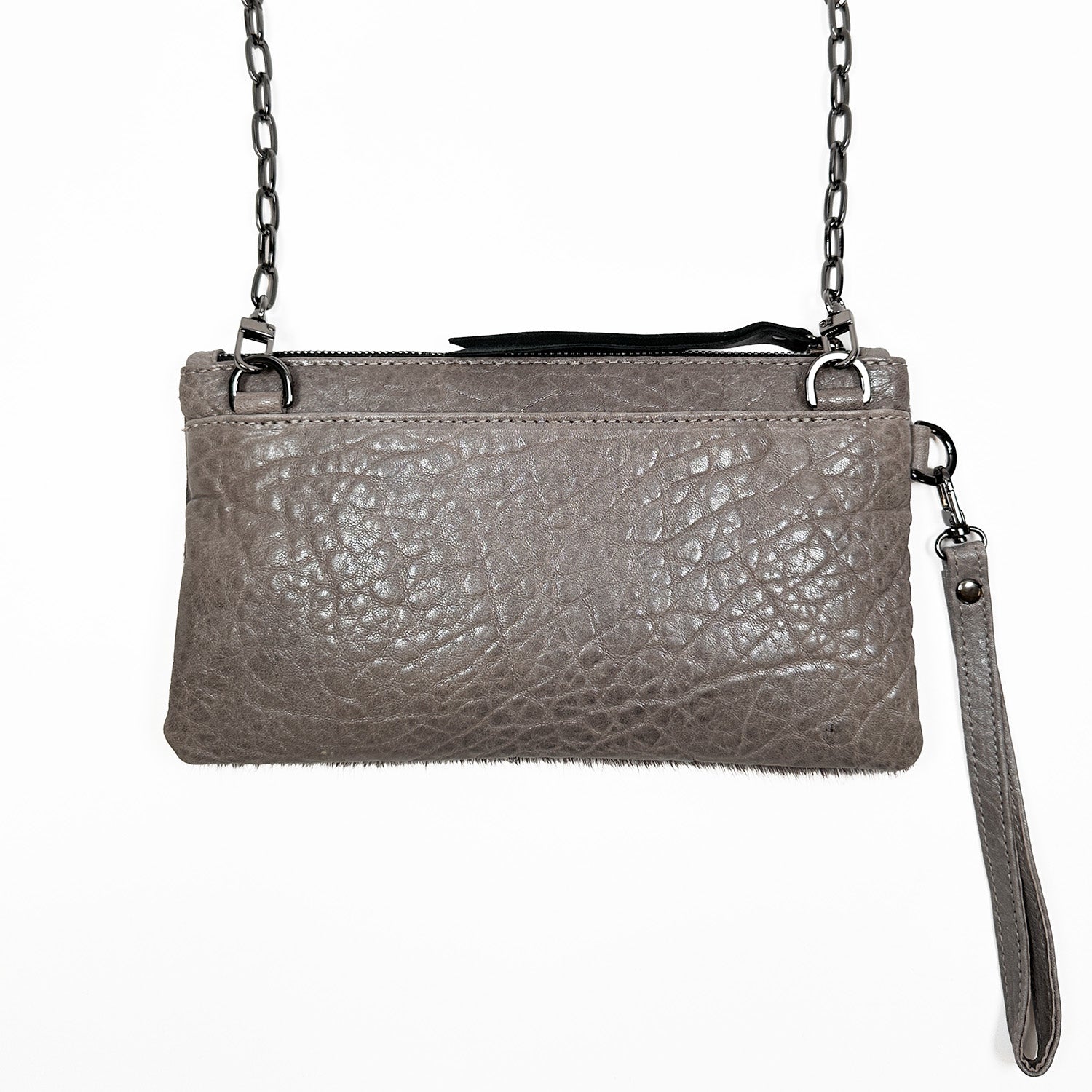 Introducing the VICTORIA clutch by evokewomen, a taupe textured leather accessory with a chain strap and wristlet attachment, adorned with a laser-engraved mushroom design, pictured against a white background.