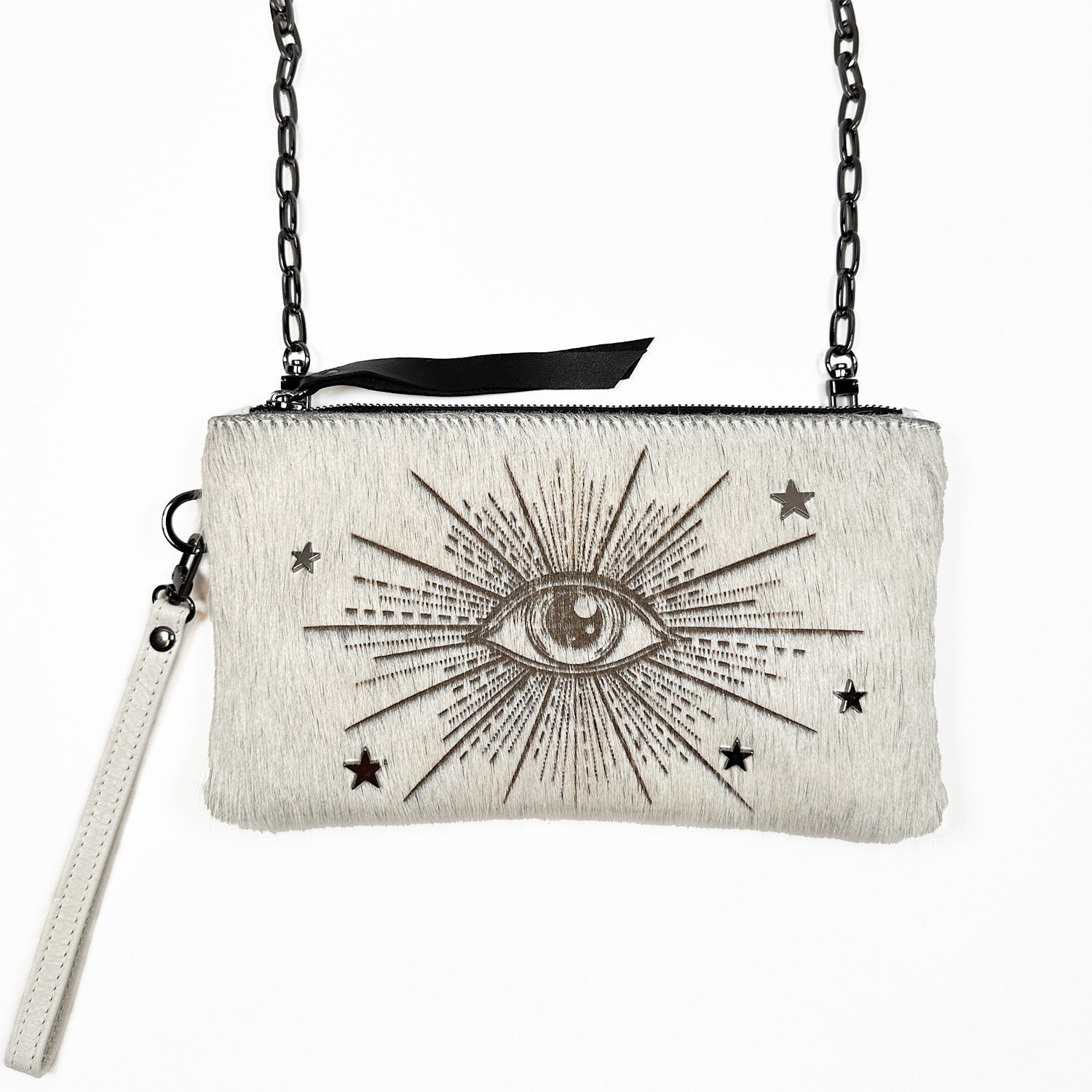 The VICTORIA off white laser eye wristlet by evokewomen features a chic chain strap and an intricate embroidered eye design with stars and rays on its textured surface, seamlessly blending the elegance of a clutch with the practicality of a crossbody bag.