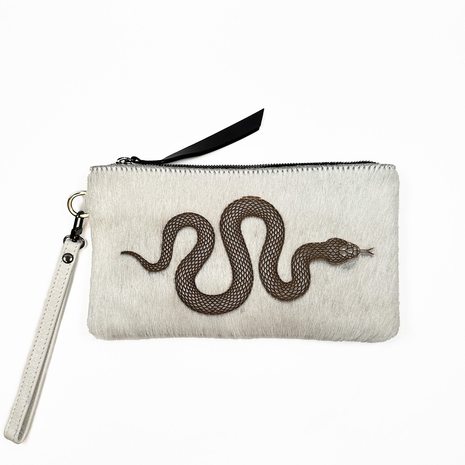 The VICTORIA - off white - laser snake clutch by evokewomen features a zipper closure and a detachable wrist strap, making it perfect for versatile use as either a wristlet or crossbody bag.