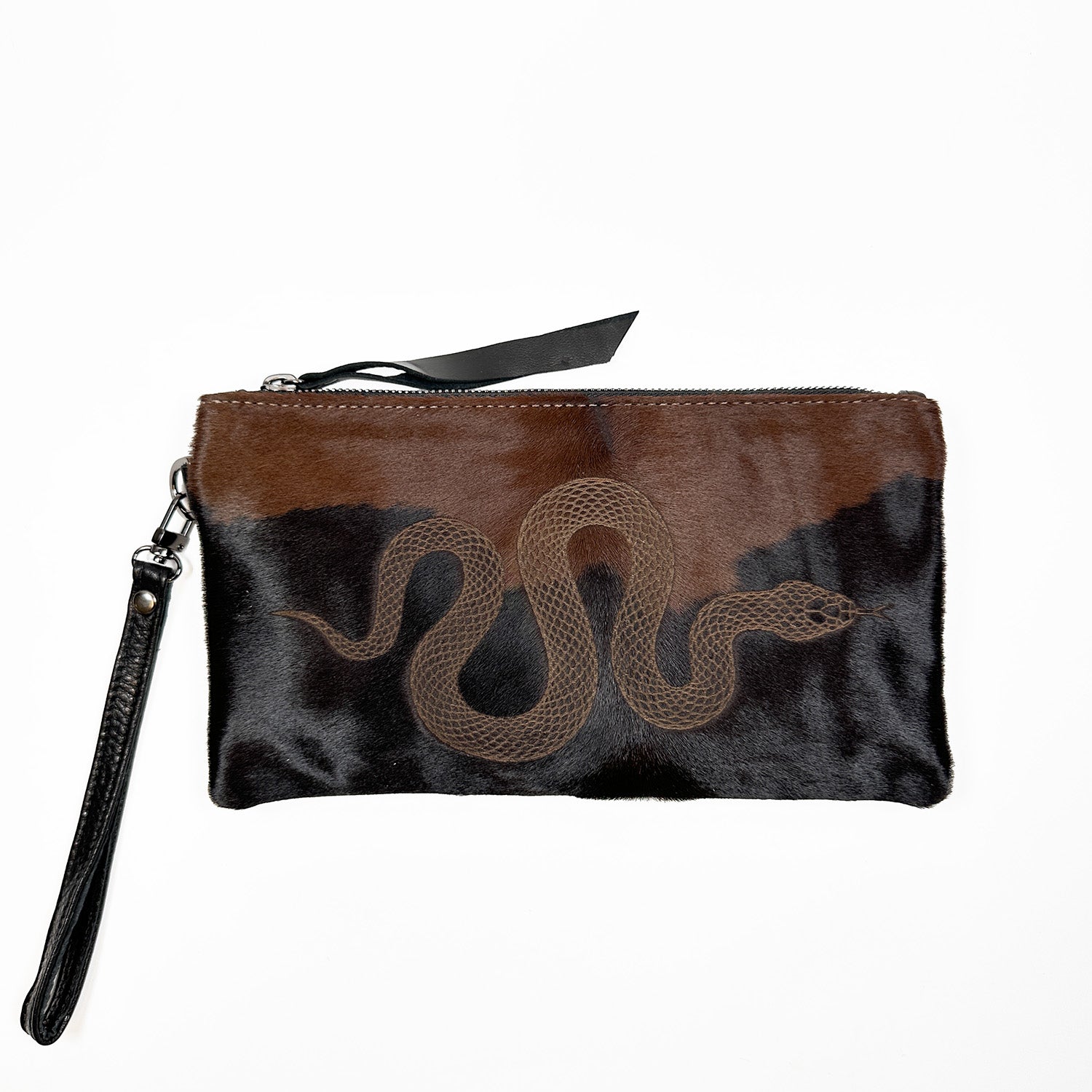 A stylish VICTORIA bag in black and brown from evokewomen, featuring a laser snake design on the front, a zipper closure, and a versatile wrist strap that allows for clutch or cross-body styling.