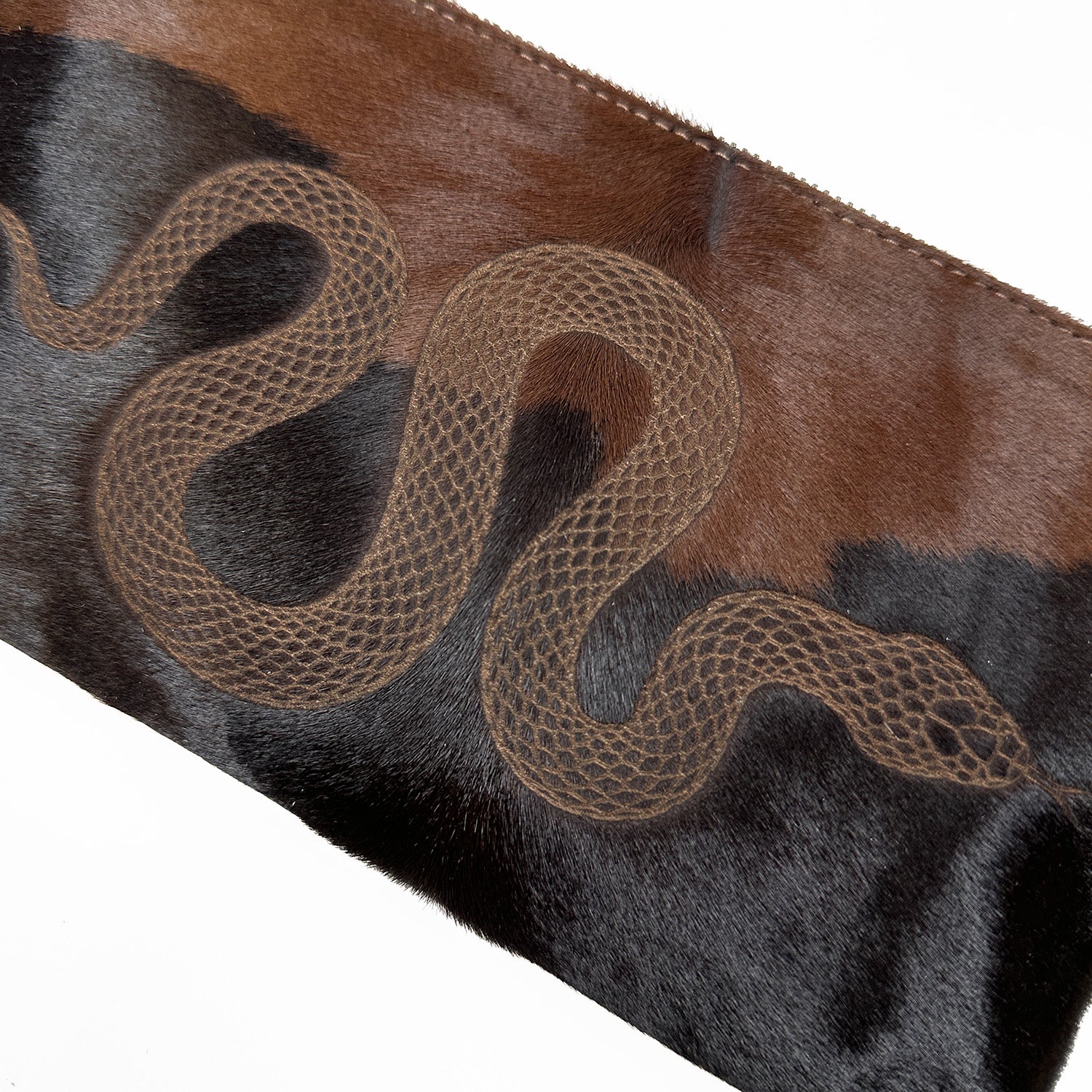 The VICTORIA by evokewomen showcases a black and brown textured material with an eye-catching laser snake design at its center.