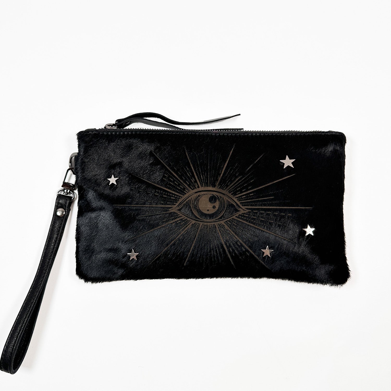 The VICTORIA black faux fur wristlet by evokewomen features a zipper and an eye design surrounded by stars.